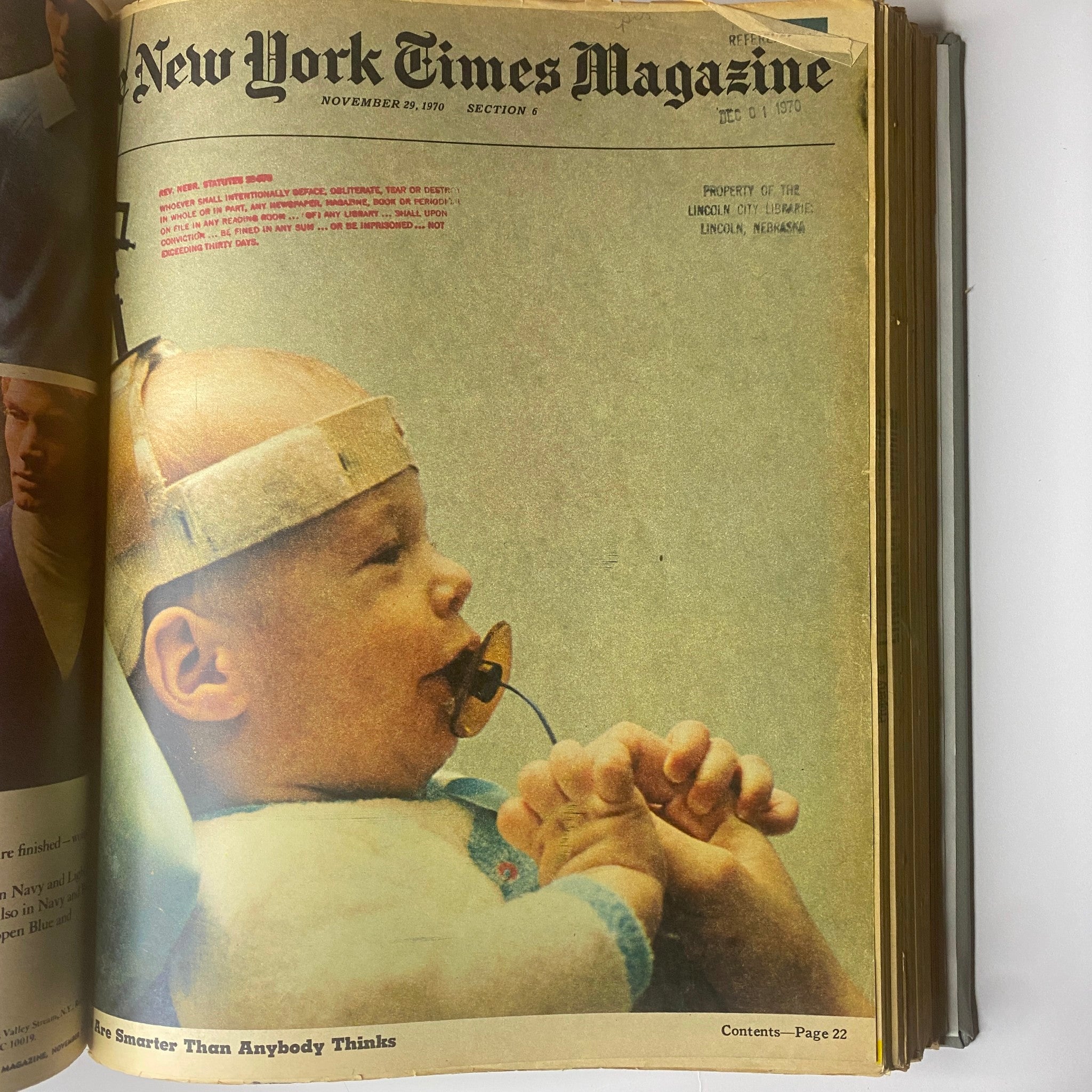 Cover of The New York Times Library Edition Bound Magazine from November 29, 1970, featuring a child with a pacifier and a hand holding their fingers.
