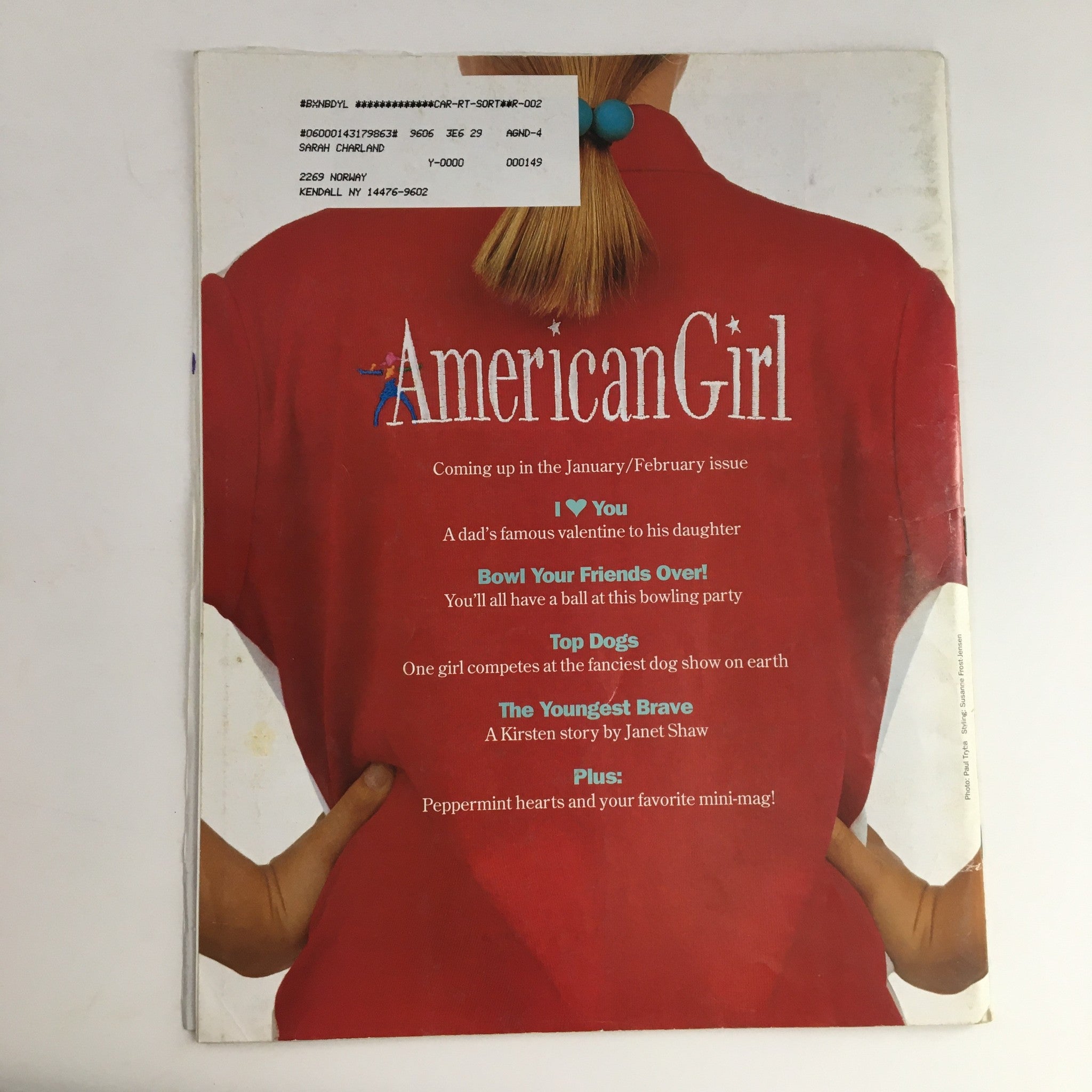 Back cover of American Girl Magazine November 1996 displaying a woman in a red shirt, with upcoming features listed, emphasizing the magazine's cultural relevance and nostalgia.