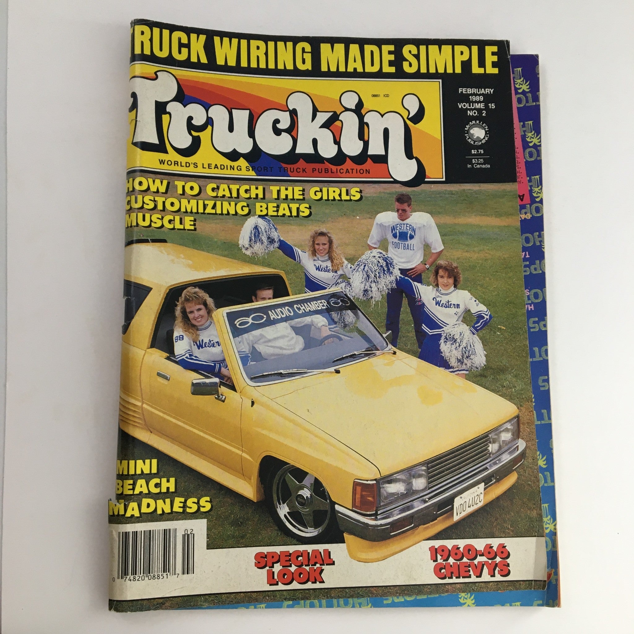 Truckin' Magazine February 1989 cover featuring Mini Beach Madness theme, showcasing a yellow truck with cheerleaders and the title 'Truck Wiring Made Simple.' Perfect for collectors and enthusiasts of 1980s truck culture.