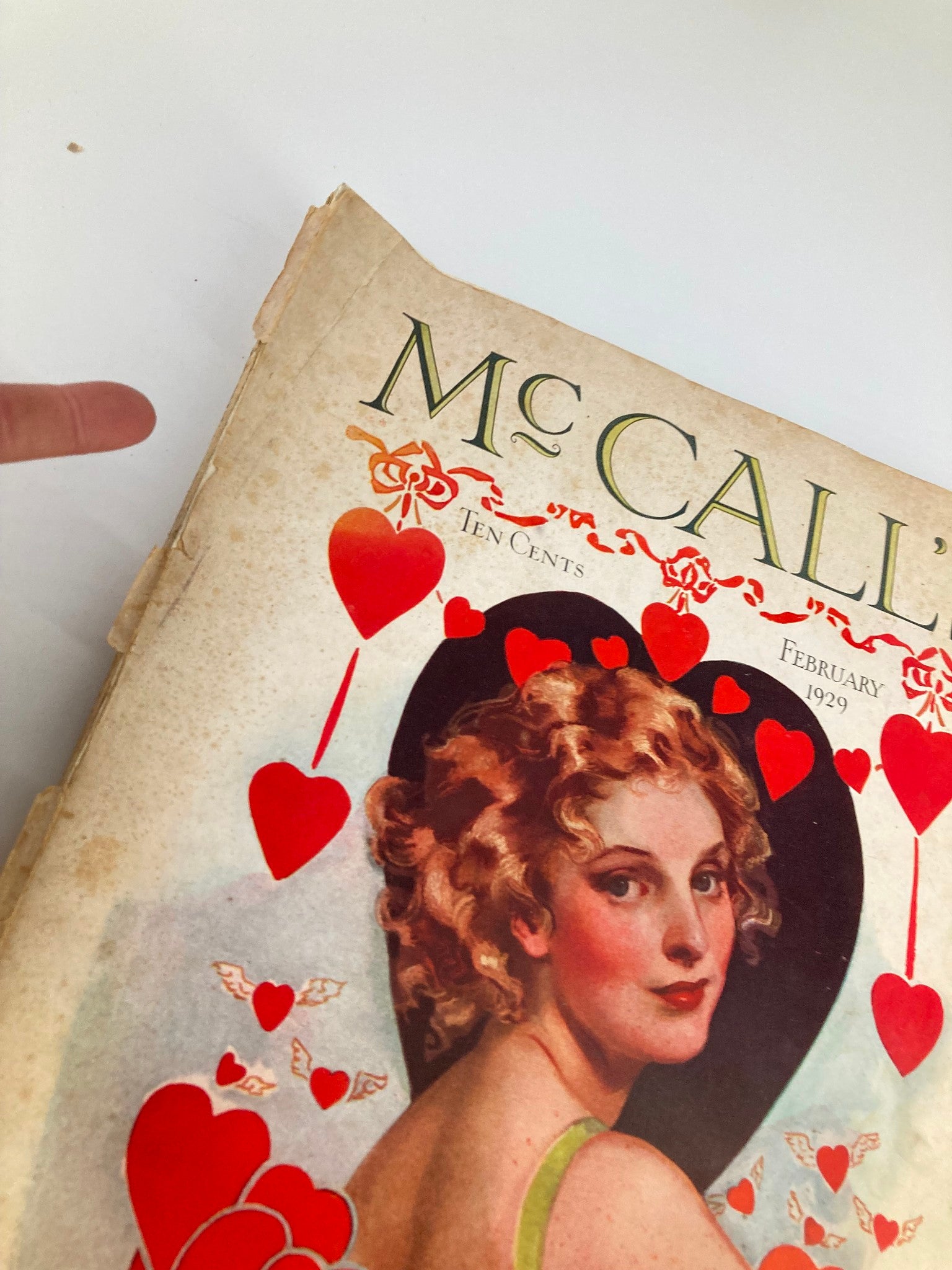Close-up view of the cover of VTG McCall's Magazine February 1929, showing details of the heart designs and the woman's portrait associated with 'The Romance Prince' by Rafael Sabatini.