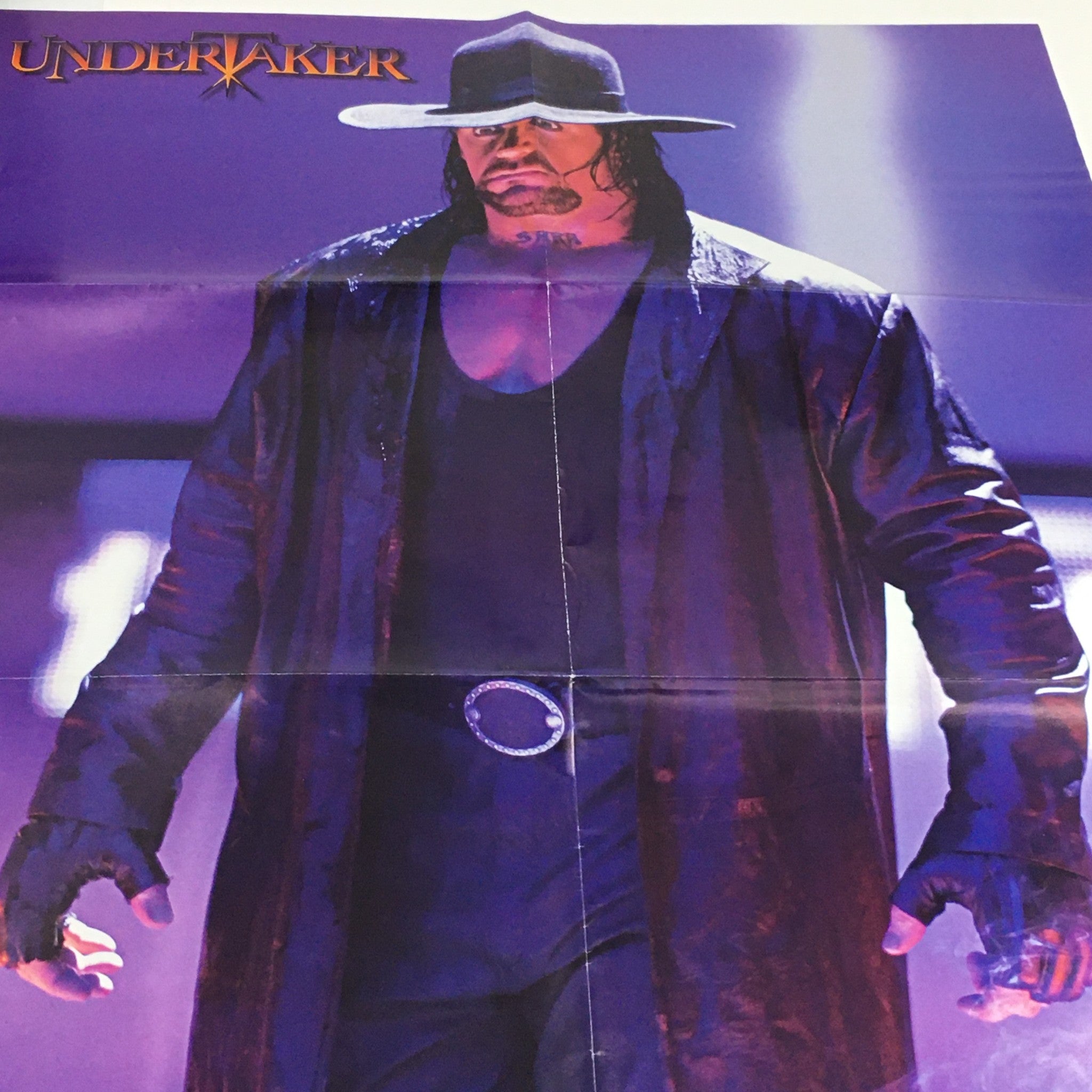 Poster included in WWE Raw Magazine March 2005, displaying The Undertaker in a dramatic pose, emphasizing his iconic persona in professional wrestling.