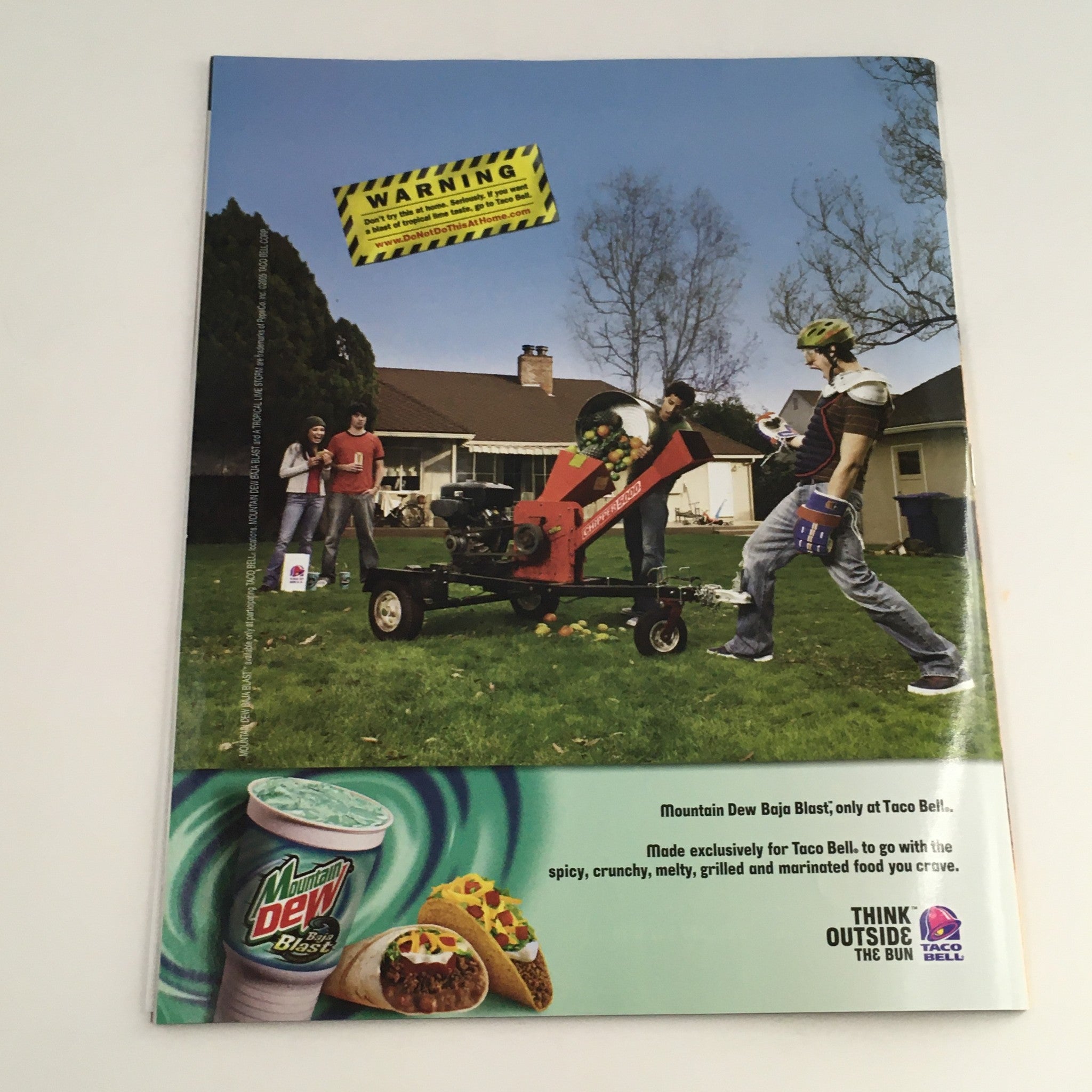 WWE Smack Down Magazine September 2005 back cover featuring a Taco Bell advertisement, creatively promoting a drink alongside a humorous outdoor scene.