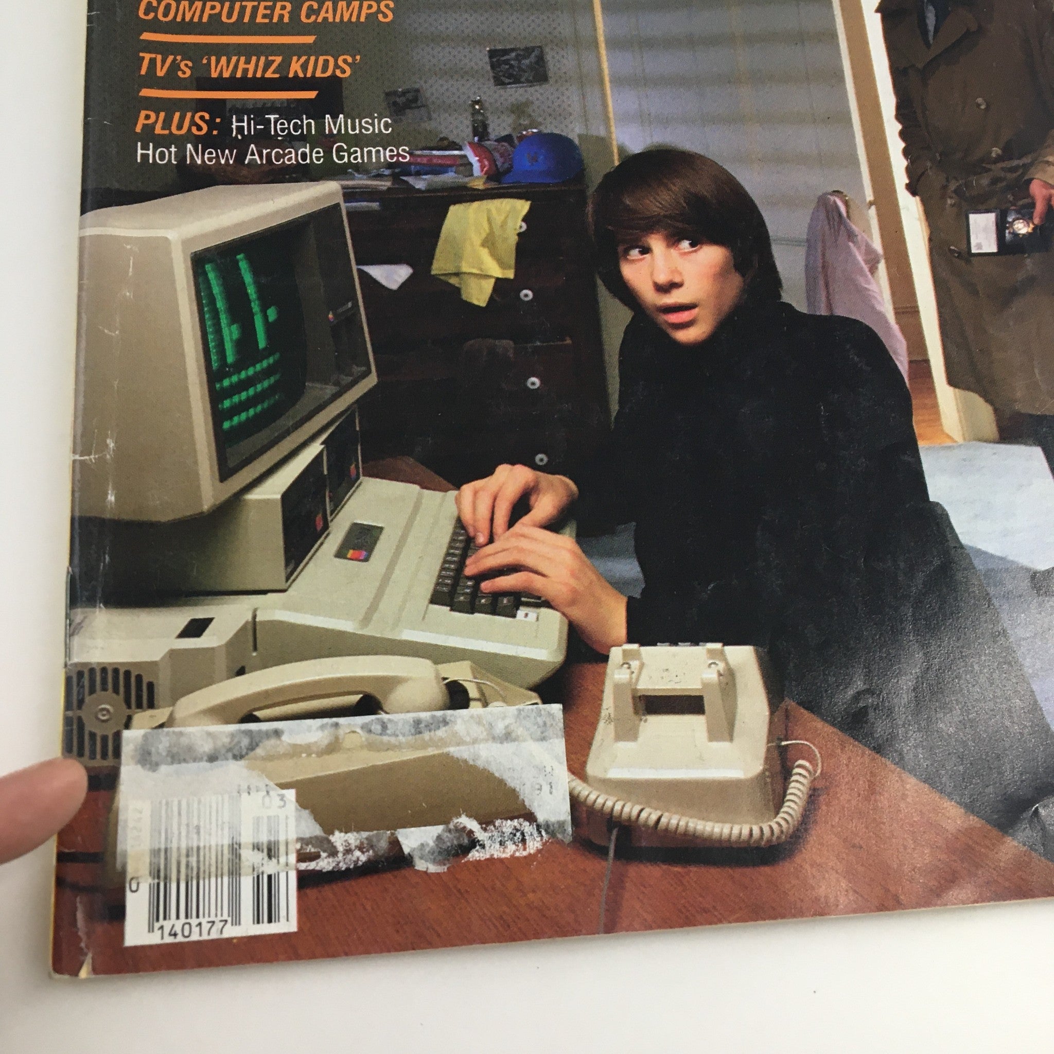 Close-up of Enter Magazine March 1984 cover, highlighting computer break-ins and features on computer camps and TV's Whiz Kids, with focused detail on the young boy at the computer.