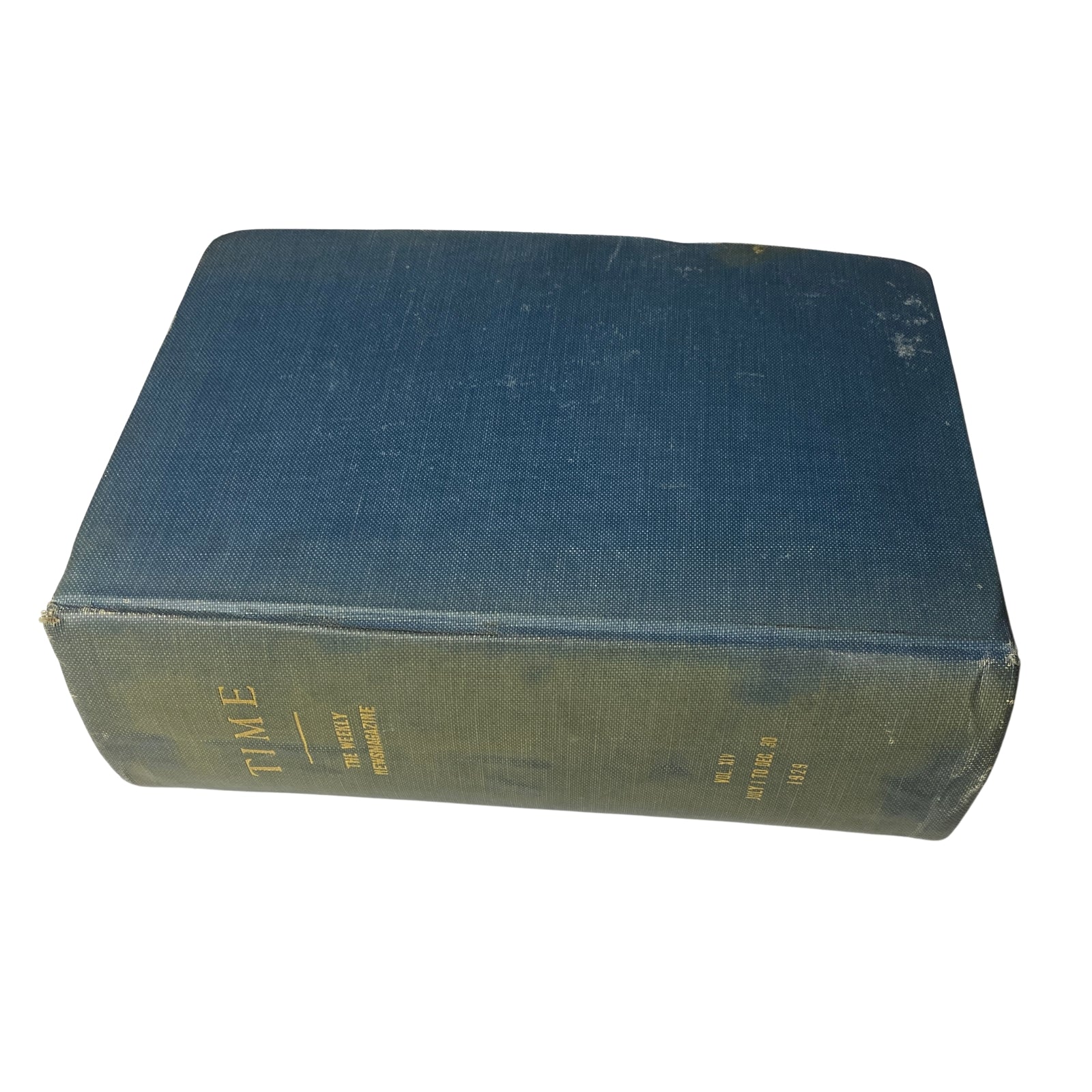 Side view of a bound volume of Time Magazine, displaying its weathered blue fabric and gold lettering, illustrating its collectible nature.
