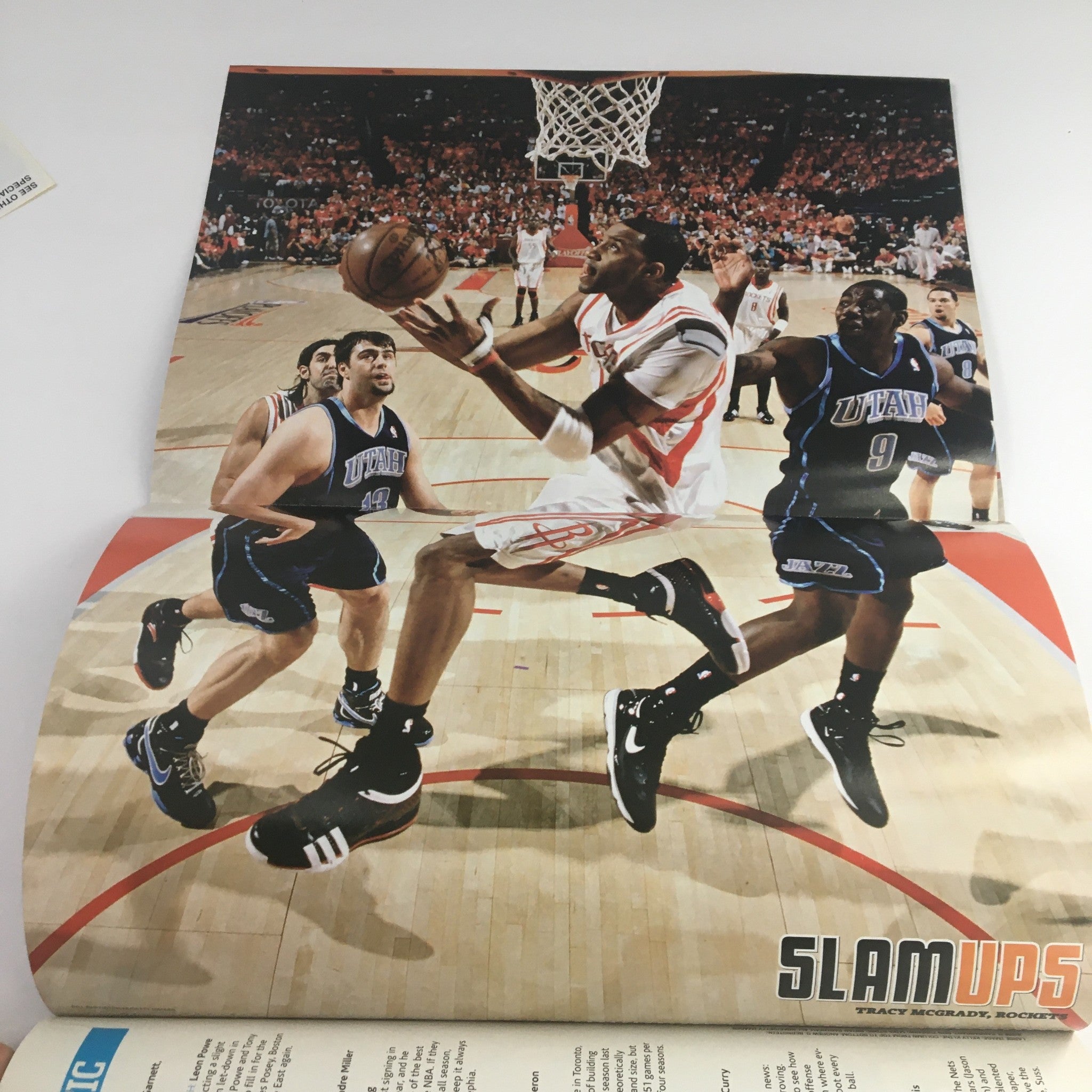 Inside spread of Slam Magazine December 2008 featuring a dynamic action shot of Tracy McGrady in his Houston Rockets uniform, part of the collectible issue with poster.