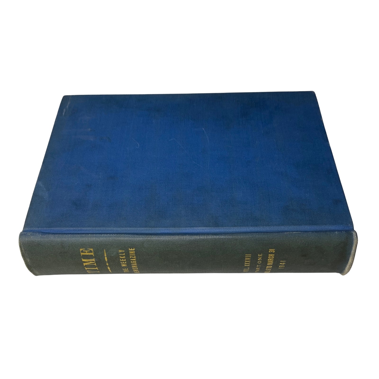 Side view of a library bound edition of Time Magazine with a blue cover, showcasing its sturdy spine and gold lettering for archival purposes.