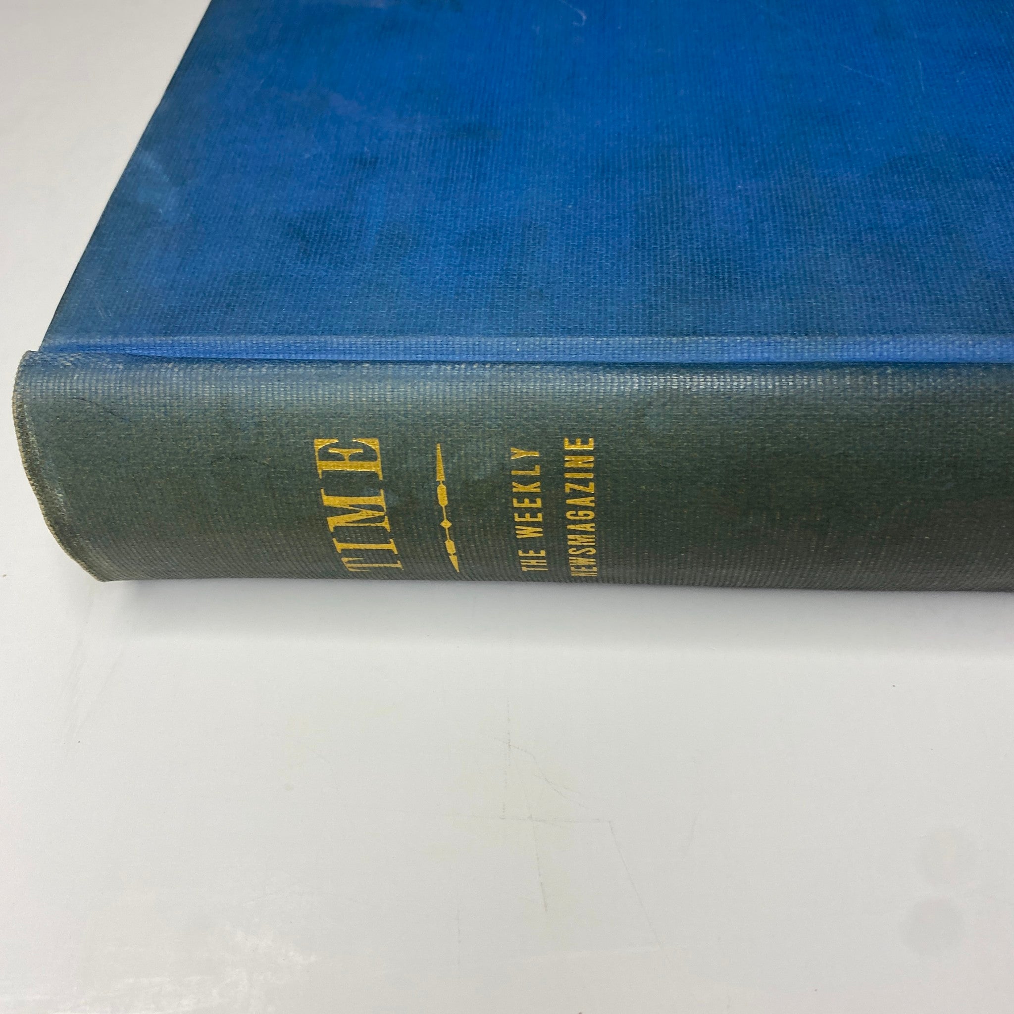 Close-up side view of the library bound Time Magazine, featuring blue cover and gold embossed text, indicating it's a historical compilation.