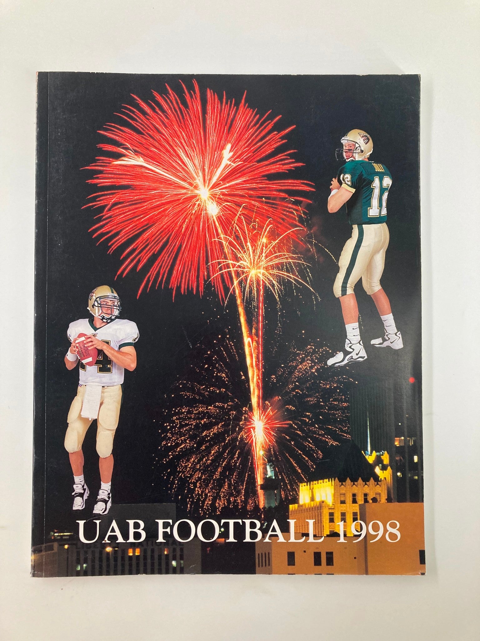Cover of the 1998 University of Alabama at Birmingham Football Media Guide featuring a dynamic design with fireworks and two football players in action, symbolizing excitement in UAB football history.
