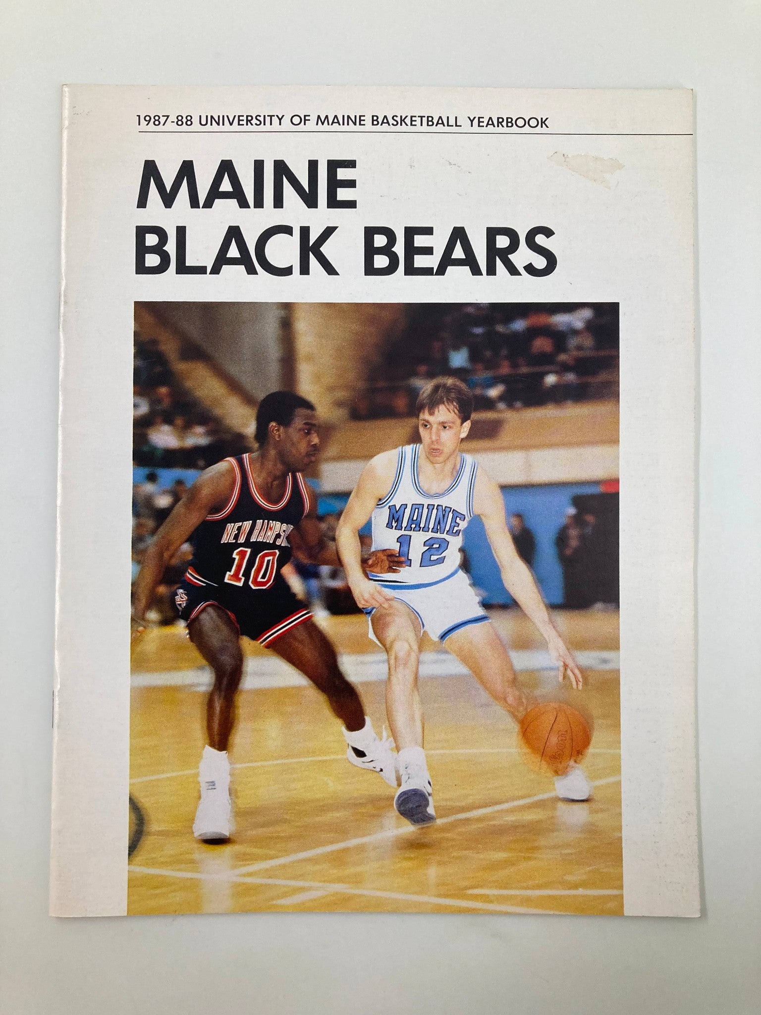 1987-88 University of Maine Basketball Yearbook featuring the Maine Black Bears cover with action shot of two players on the court.
