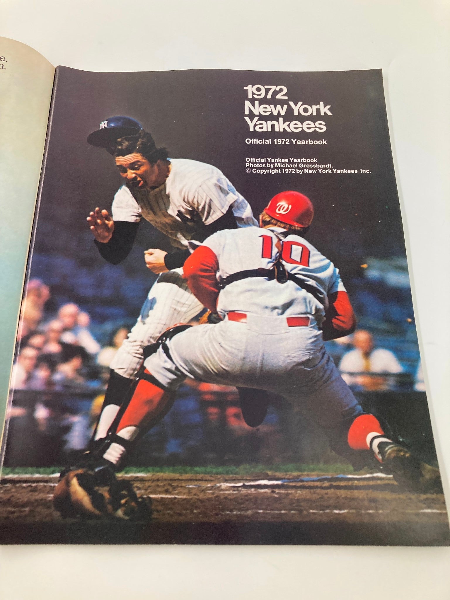 Cover of the 1972 MLB New York Yankees Official Yearbook featuring Ralph Houk, showcasing a dramatic baseball play.