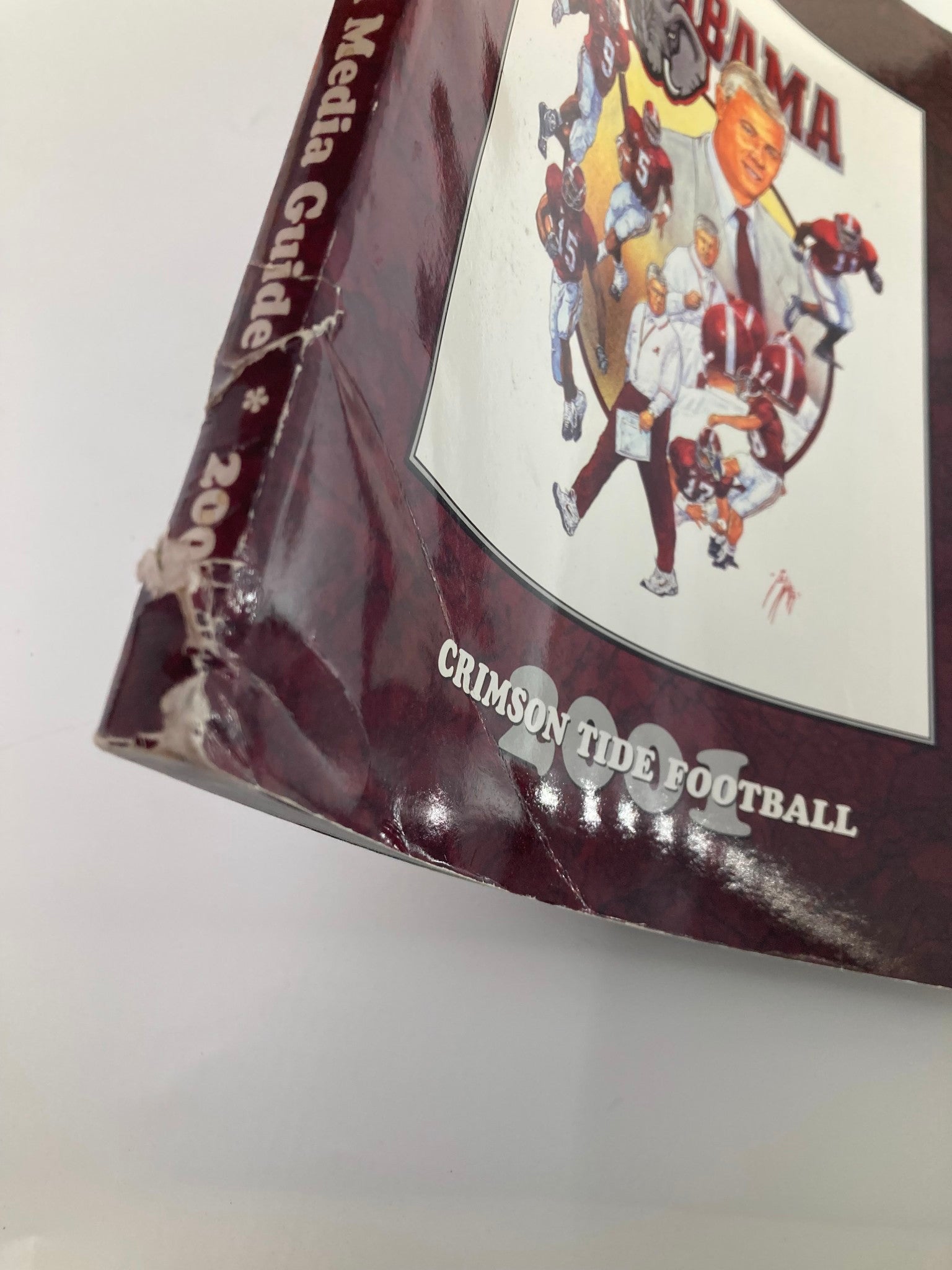Close-up of the spine of the 2001 Alabama Crimson Tide Football Official Program, highlighting the wear and details of this vintage sports publication.