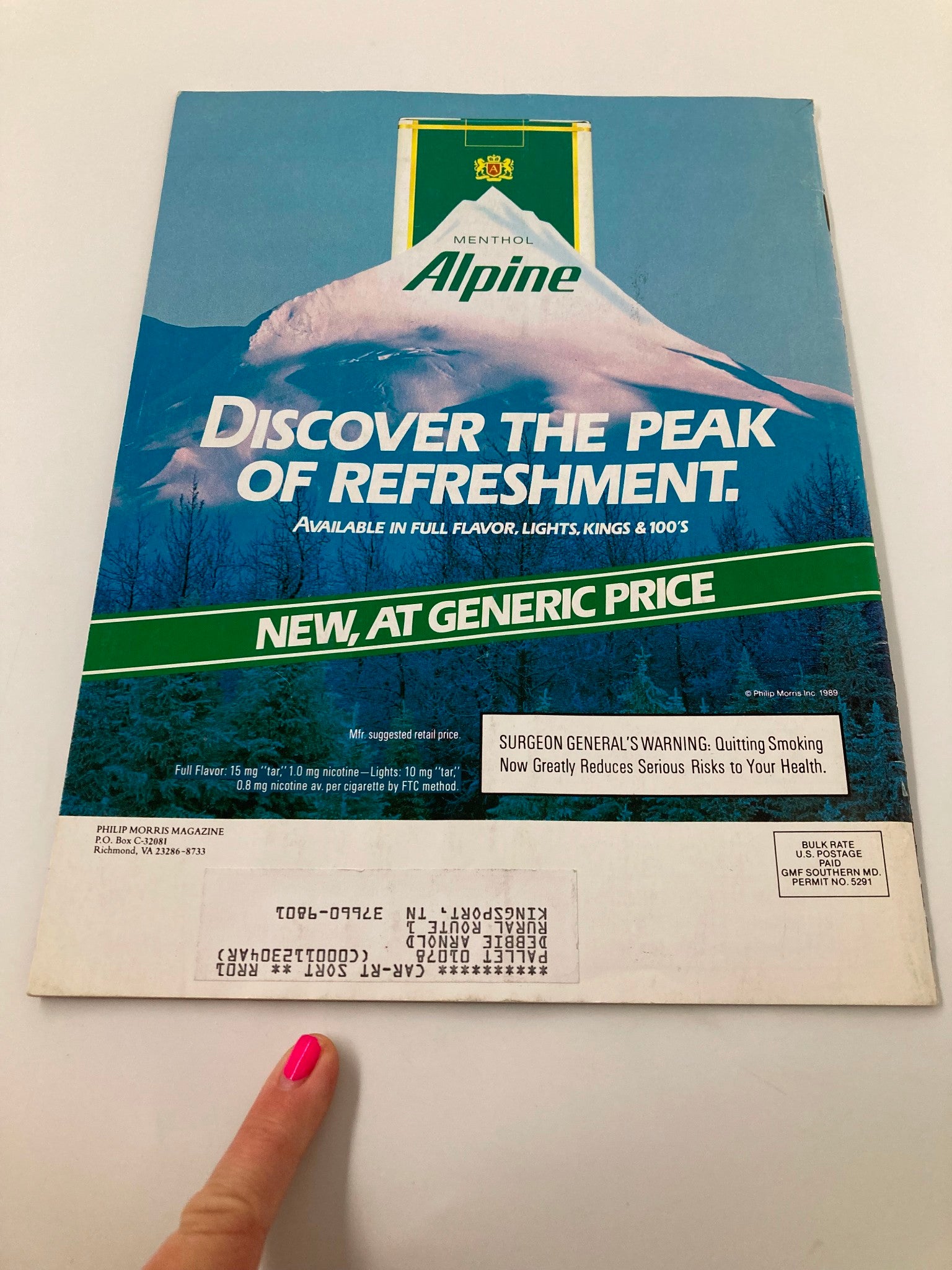 Back cover of the VTG Philip Morris Magazine from March 1989, Volume 4, Number 2, featuring a promotional advertisement for Menthol Alpine cigarettes, highlighting the product's refreshing qualities with a scenic mountain background and smokes warnings.