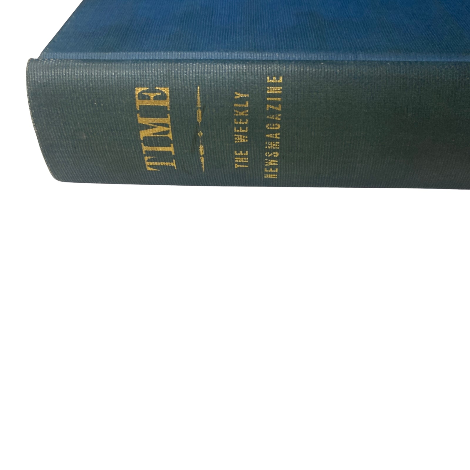 Another view of the library bound Time Magazine, highlighting the blue cloth cover and golden text, encapsulating historical journalism.
