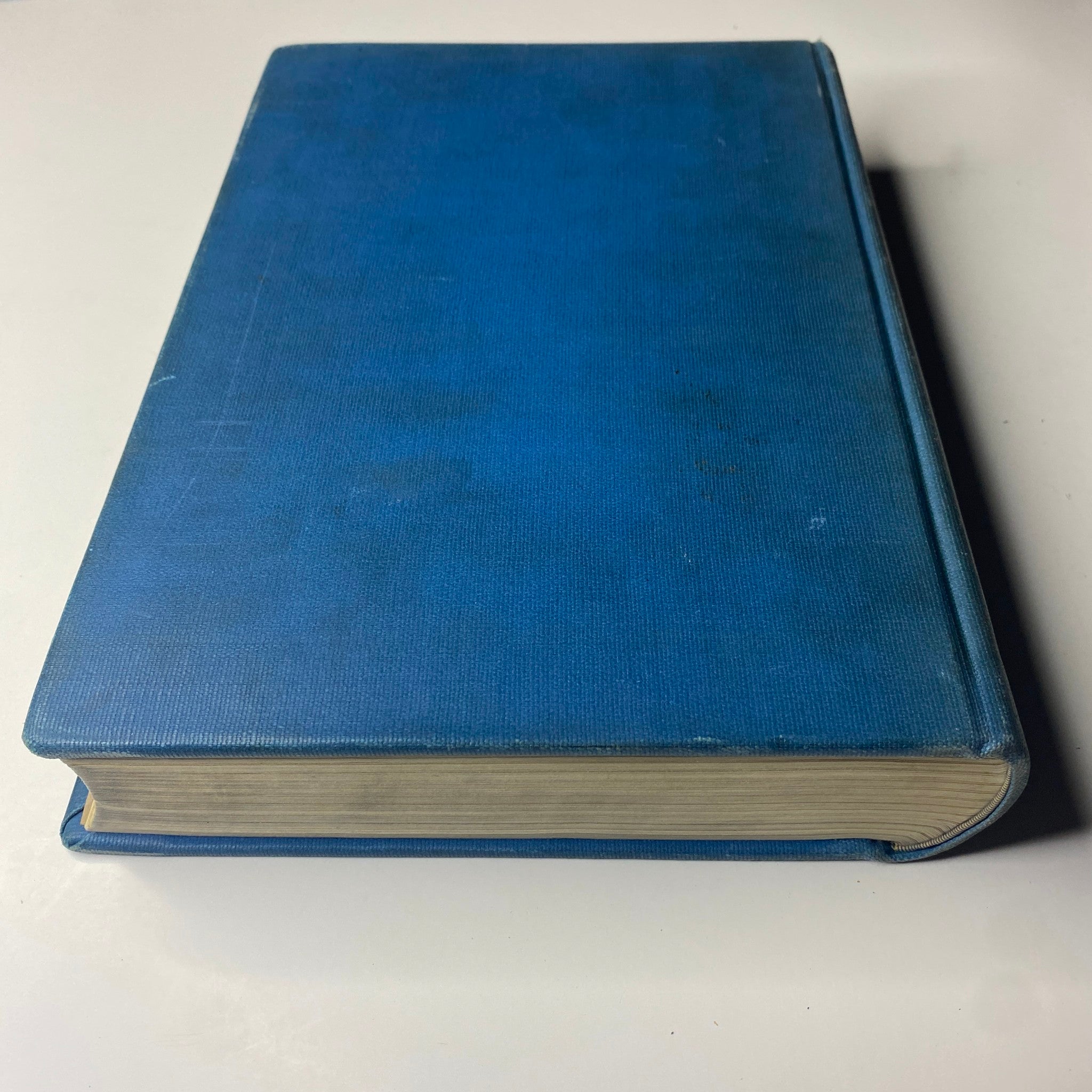 Side view of the 'Time Magazine Library Bound Weekly' volume, highlighting its solid blue cover and thickness.