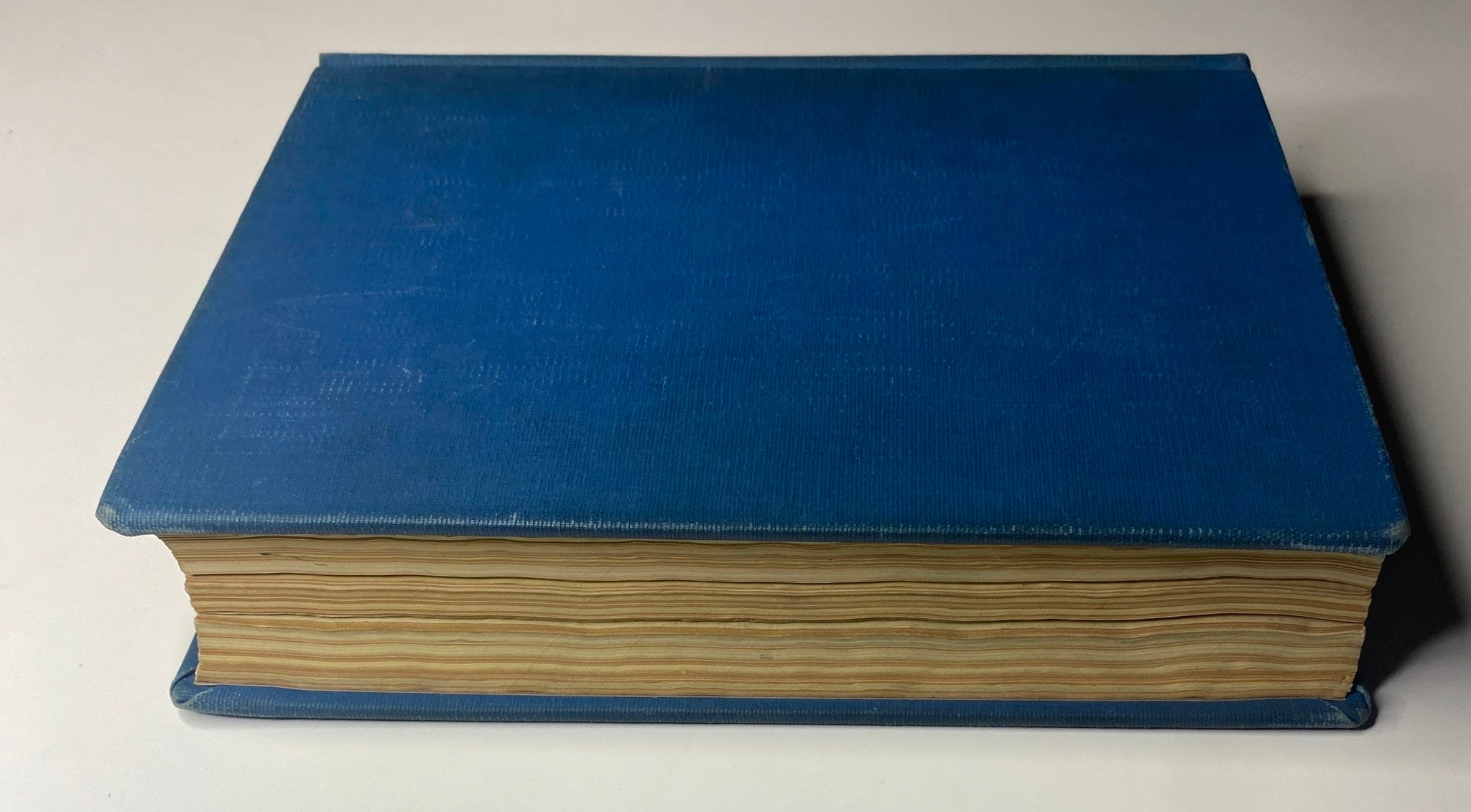 Top view of a blue library-bound Time Magazine from July 5 to September 27, 1943, illustrating the book's thickness and age with carefully bound pages.