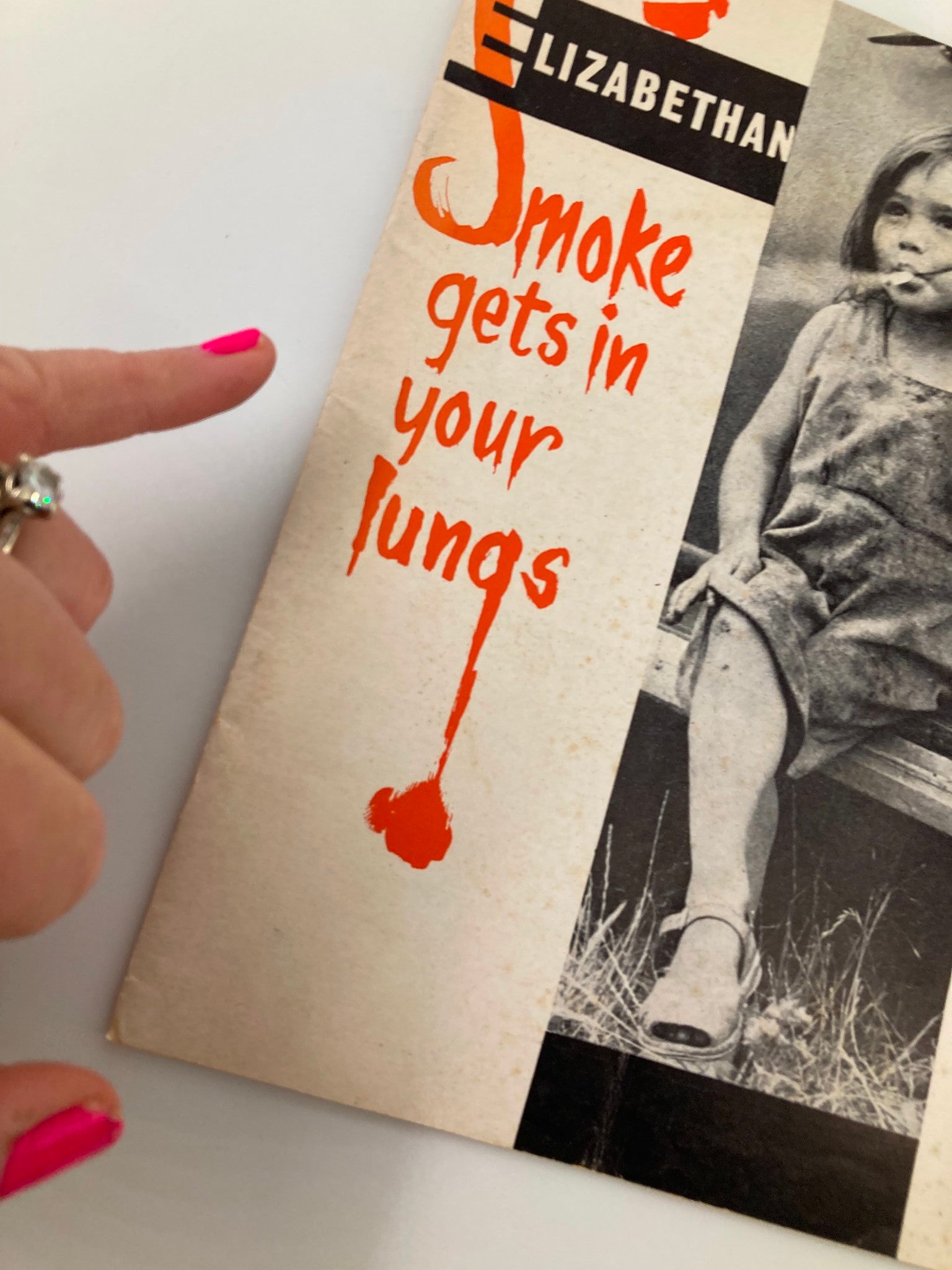 Close-up of the cover of the VTG Elizabethan Teenage Magazine, emphasizing the title 'Smoke Gets In Your Lungs' with a girl's portrait.
