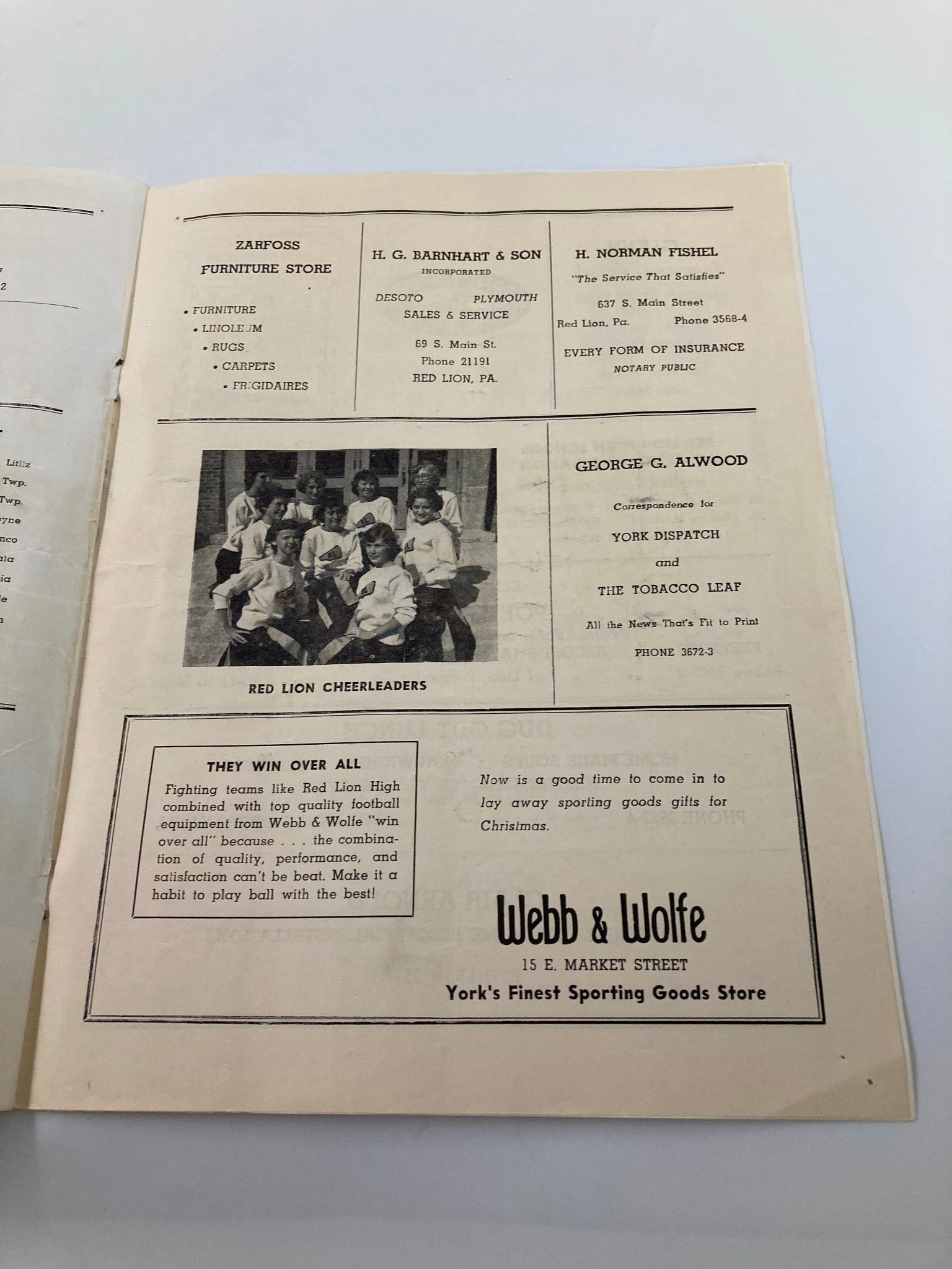 A page from the September 13 1952 High School Football program displaying ads for local businesses, including Red Lion Furniture Co. and Webb & Wolfe Sporting Goods.