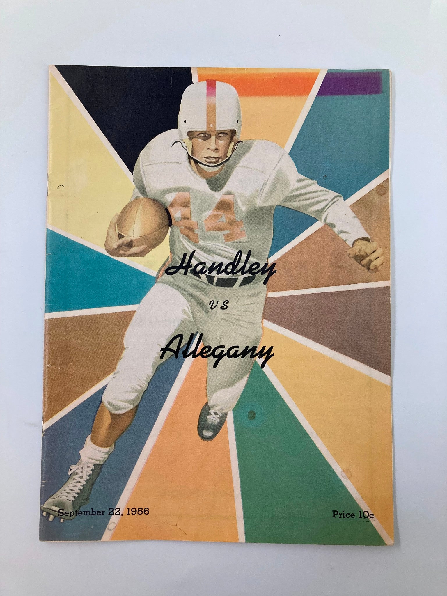 Vintage September 22, 1956 football program cover for Handley vs Allegany, featuring a player in a white uniform with number 44, set against a colorful geometric background.