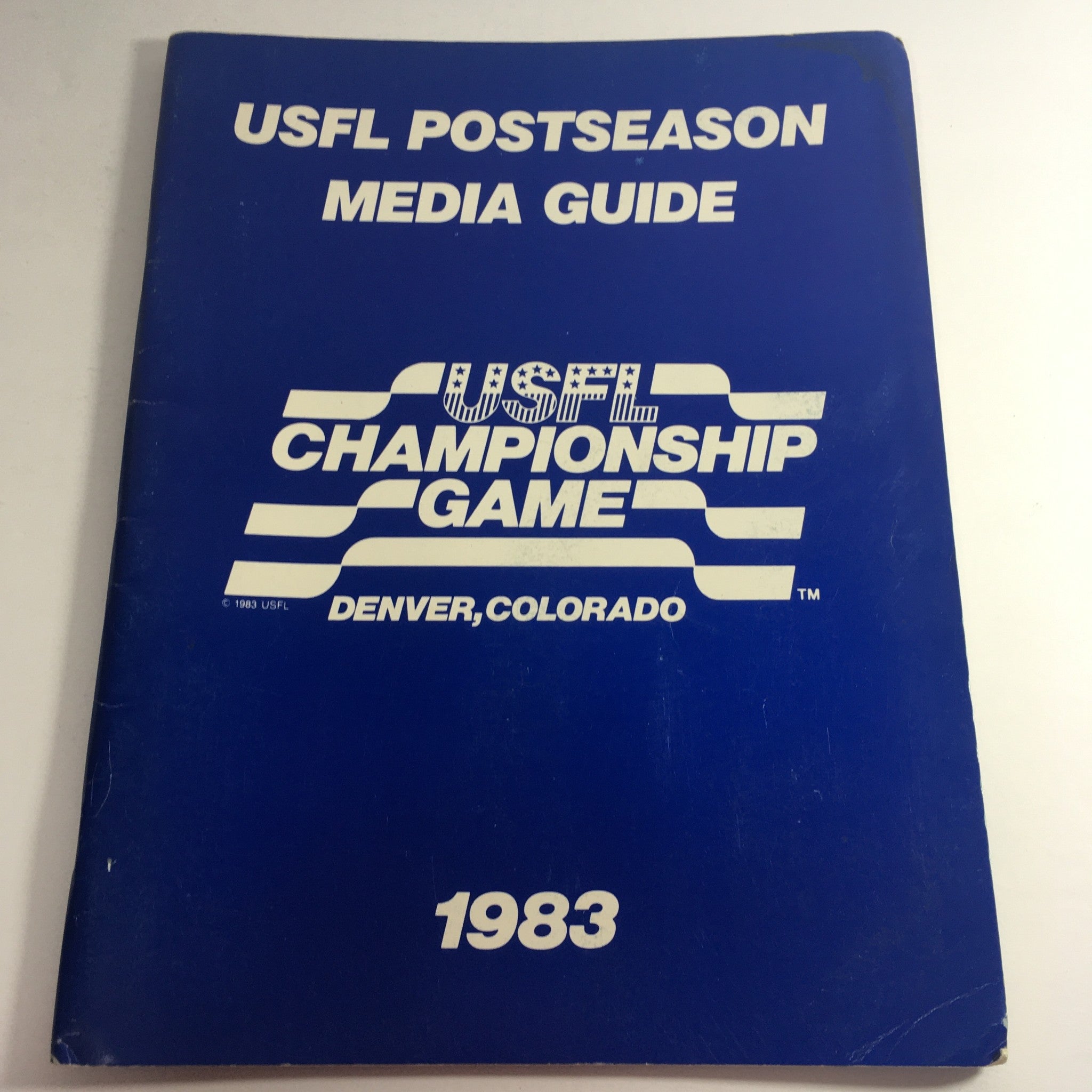 1983 USFL Championship Game Media Guide cover featuring the title 'USFL Postseason Media Guide' in blue with white text, representing the official publication for the USFL Championship Game.