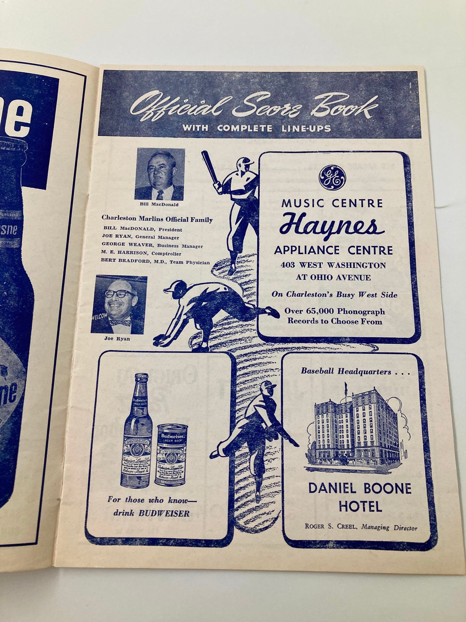 Interior page of the 1961 Charleston Marlins Watt Powell Park Official Score Book showcasing advertisements and profiles of team officials like Bill MacDonald and Joe Ryan.