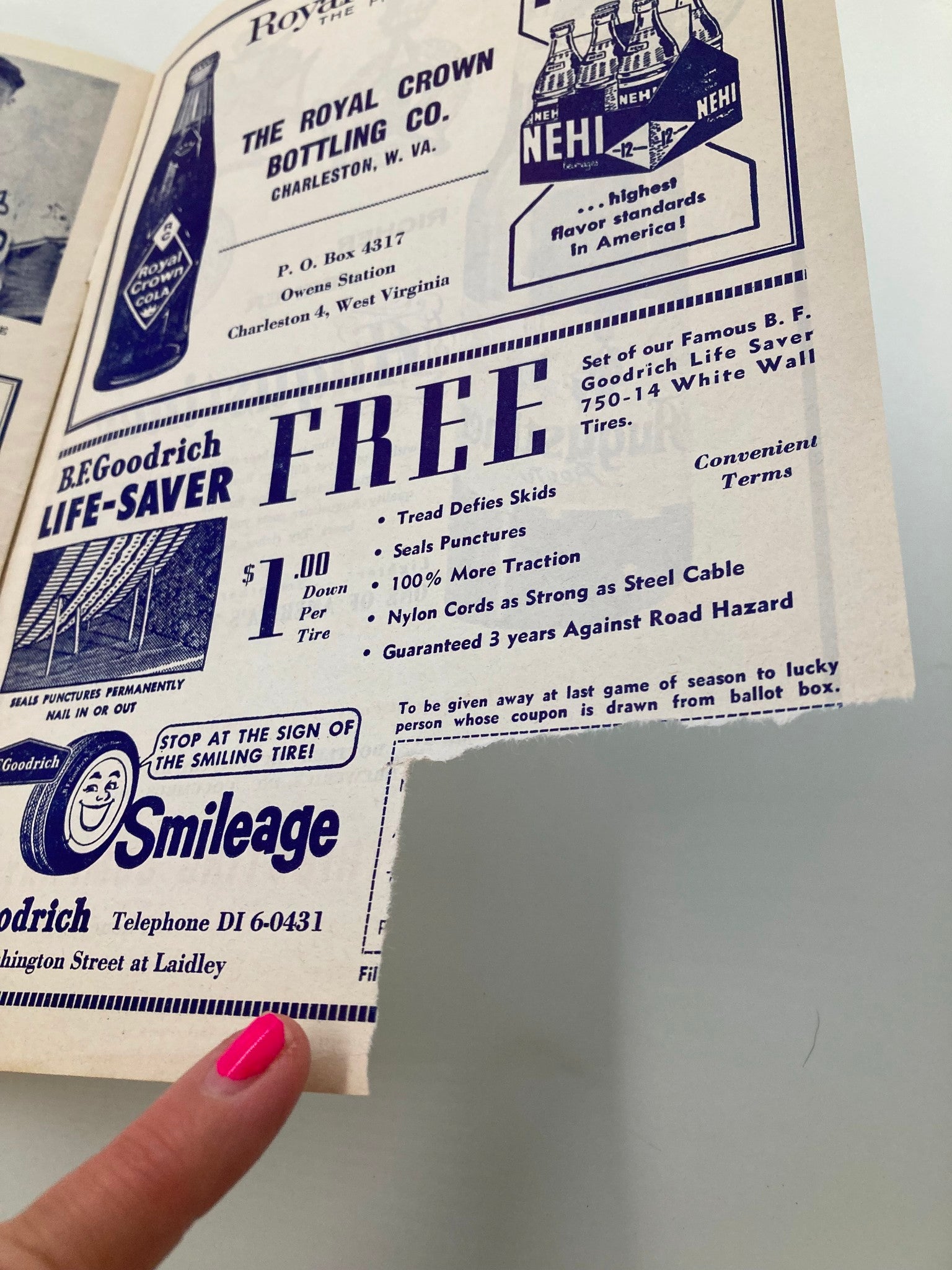 1961 Charleston Marlins Watt Powell Park Official Score Book showing a vintage advertisement for Royal Crown Bottling Co. and B.F. Goodrich tires, highlighting features like sealing punctures and a special offer.