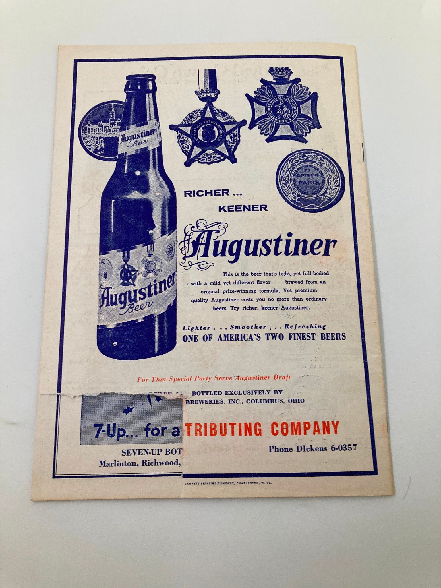 1961 Charleston Marlins Watt Powell Park Official Score Book displaying an advertisement for Augustiner Beer with medals, emphasizing its unique flavor and quality.