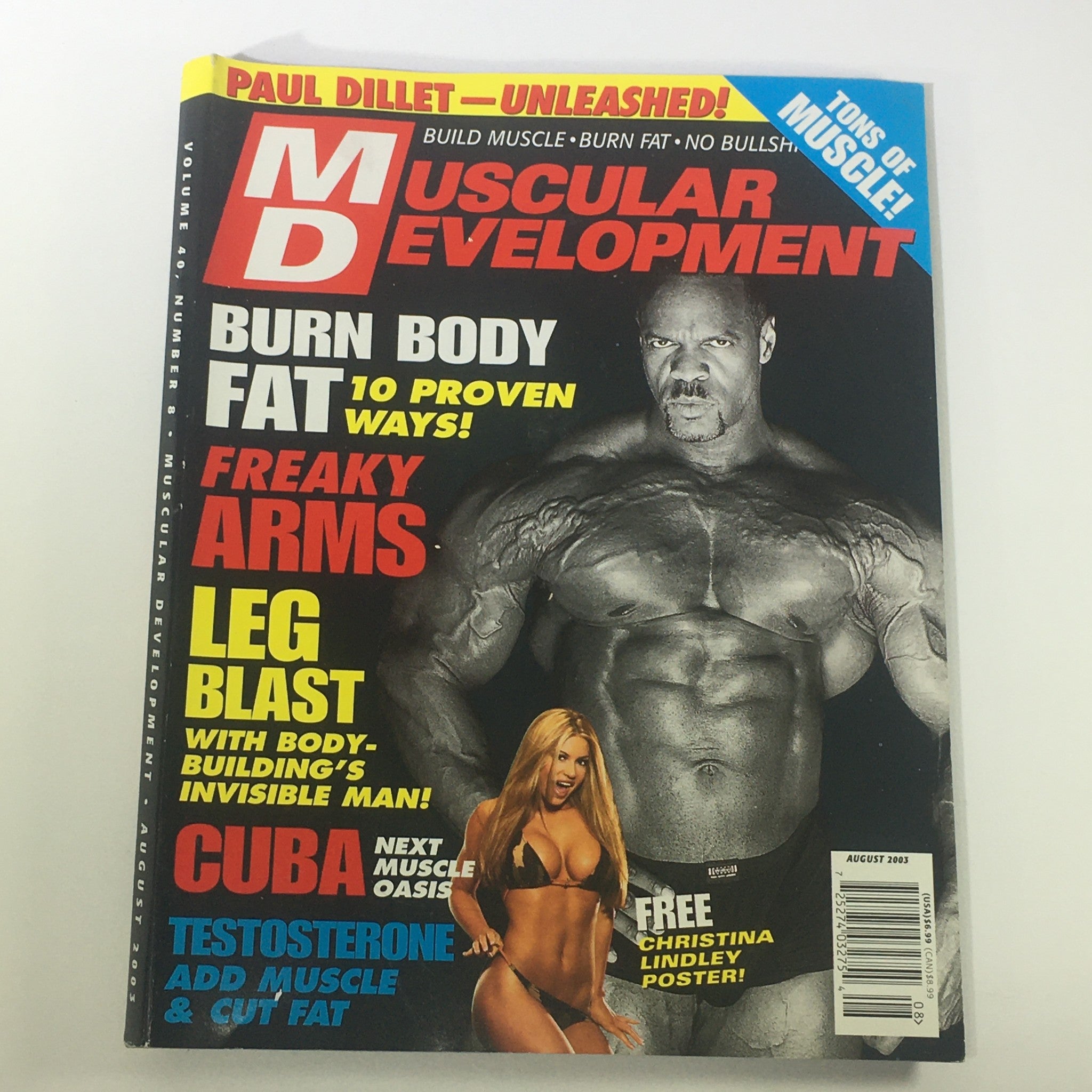 Cover of Muscular Development Magazine August 2003 featuring Ronnie Coleman and Christina Lyndley, highlighting bodybuilding news and fitness tips. The cover emphasizes weight loss techniques, arm workouts, and a special poster, making it a collectible issue for fitness enthusiasts.
