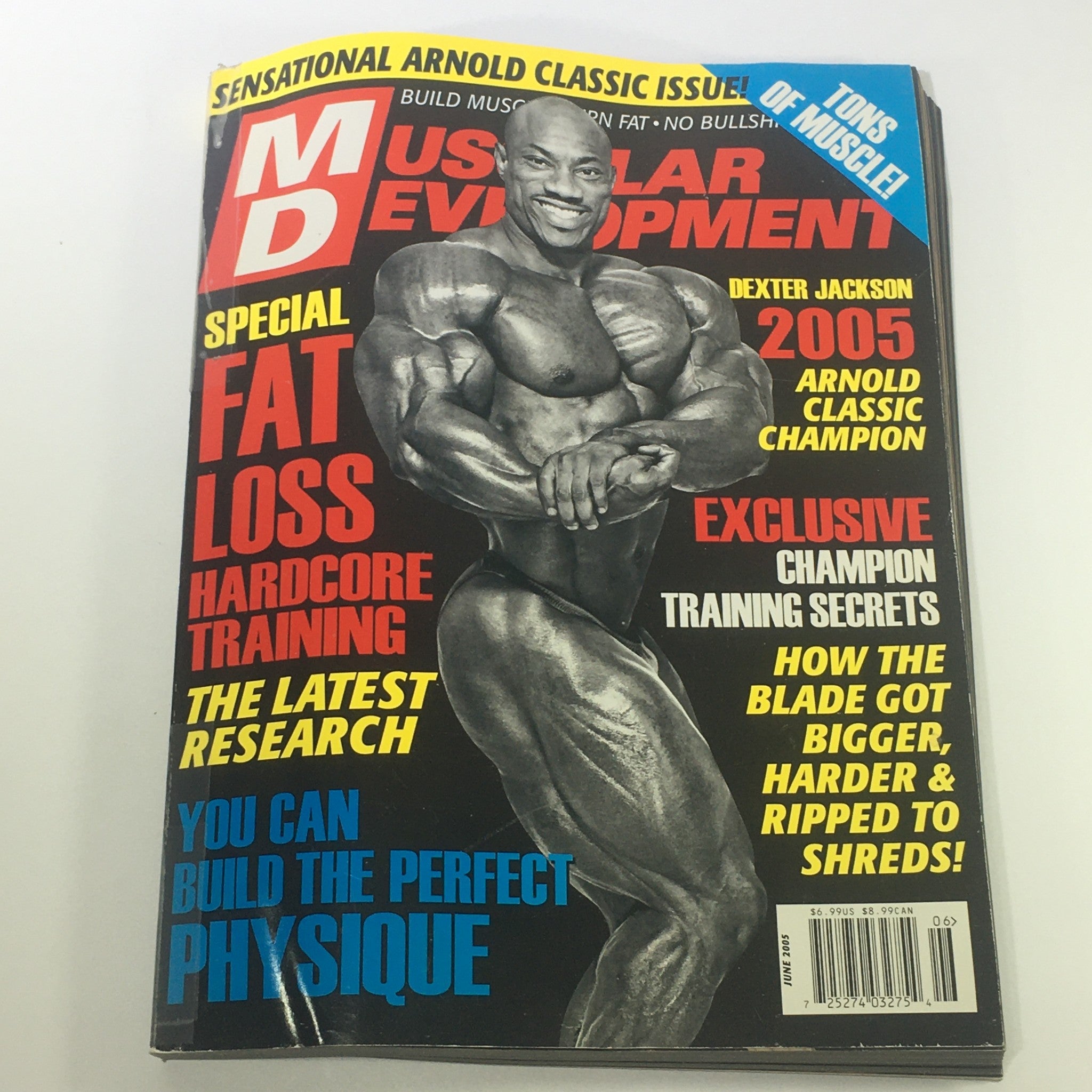 Cover of Muscular Development Magazine June 2005 featuring Dexter Jackson showcasing a muscular physique, highlighting the bodybuilding theme and the iconic Arnold Schwarzenegger.