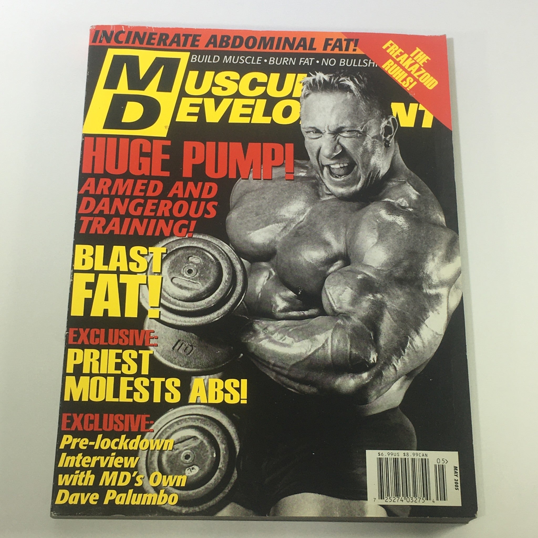 Cover of Muscular Development Magazine May 2005 featuring an interview with Dave Palumbo. The cover showcases a muscular bodybuilder lifting dumbbells, emphasizing themes of fitness and bodybuilding culture from the early 2000s.