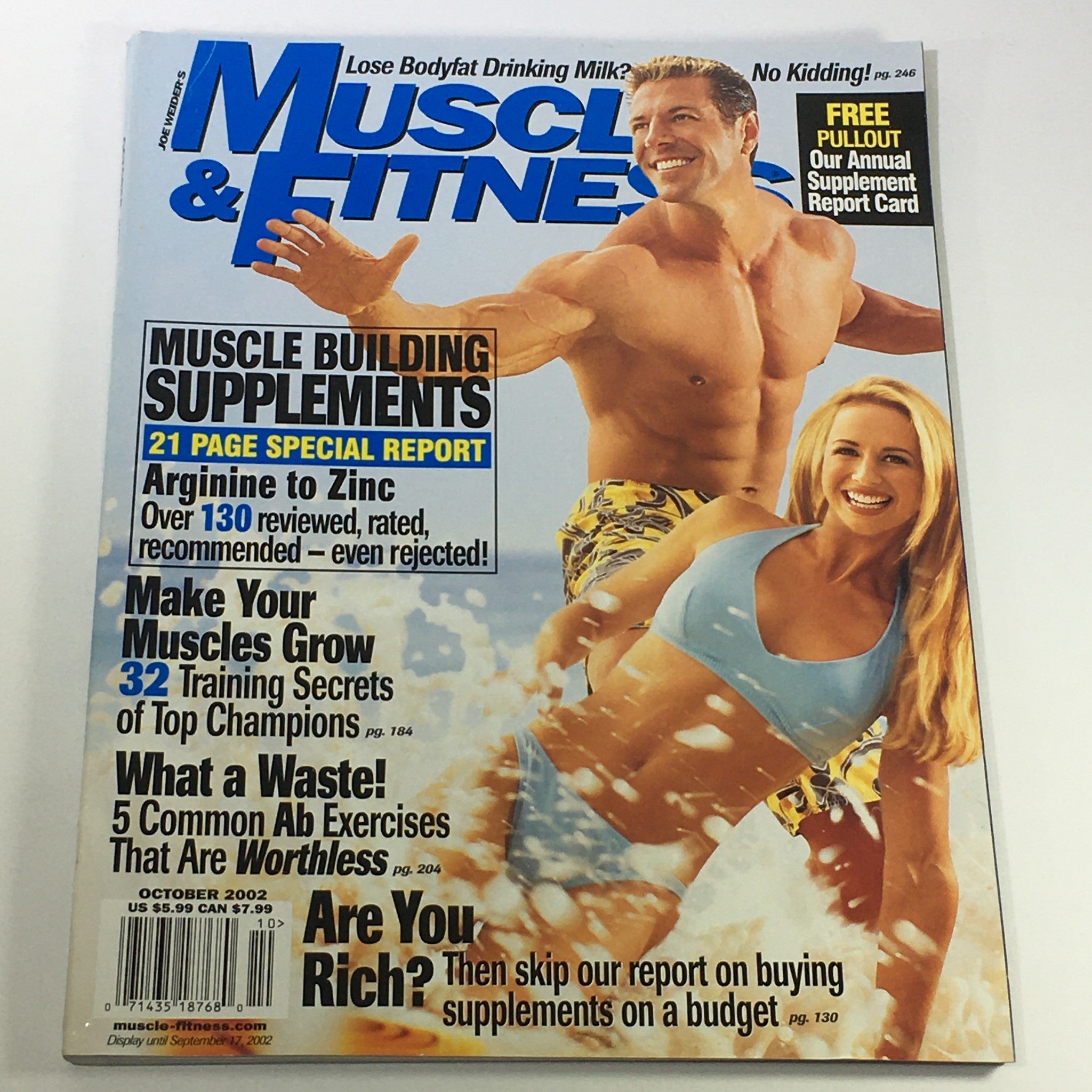 Cover of Joe Weider's Muscle & Fitness Magazine from October 2002 featuring models demonstrating fitness techniques. The magazine highlights muscle building supplements and training secrets, capturing the essence of early 2000s fitness culture.