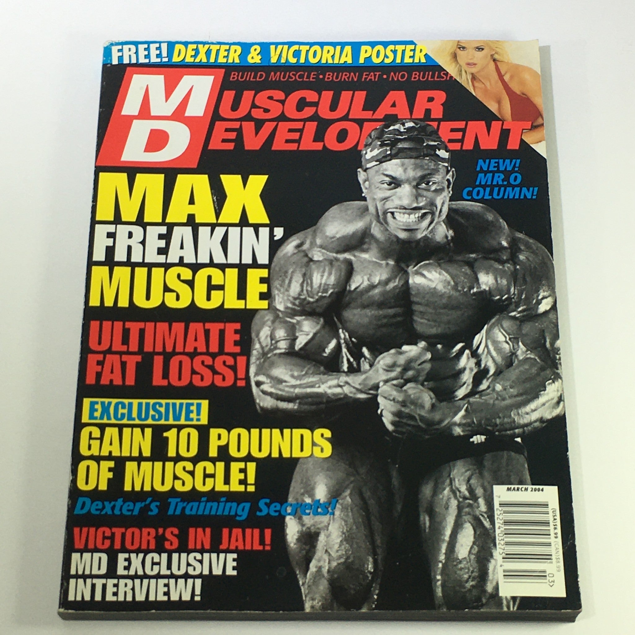 Cover of Muscular Development Magazine March 2004 featuring Dexter Jackson, with a focus on bodybuilding, extreme fitness, and nutritional insights. Includes headline on muscle gain and a poster offer.