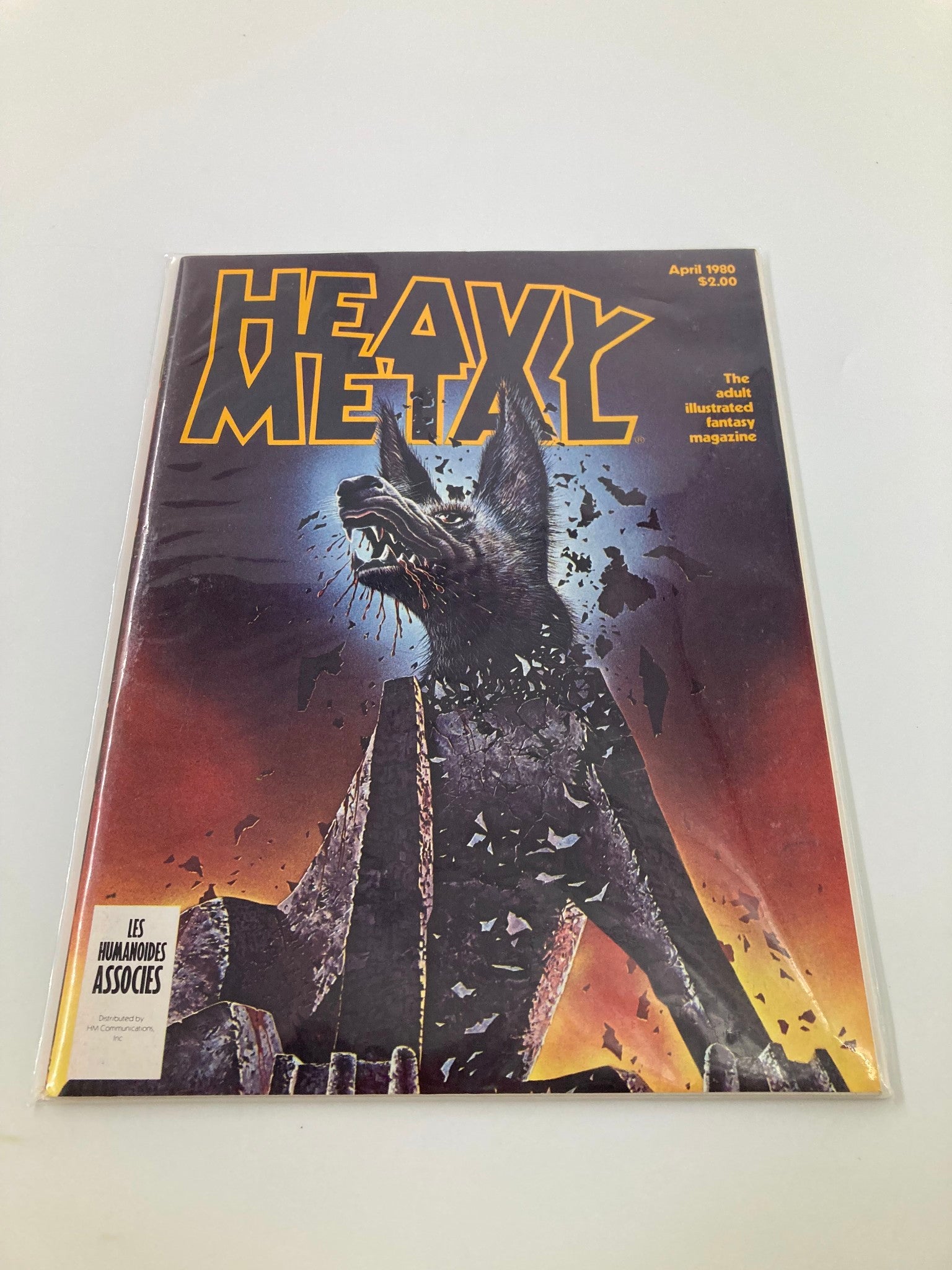 Cover of VTG Heavy Metal Magazine April 1980 featuring the artwork related to the story 'He Turned the Phindog to Stone.' The magazine showcases a dramatic illustration of a wolf-like creature against a fiery background, capturing the essence of adult illustrated fantasy.