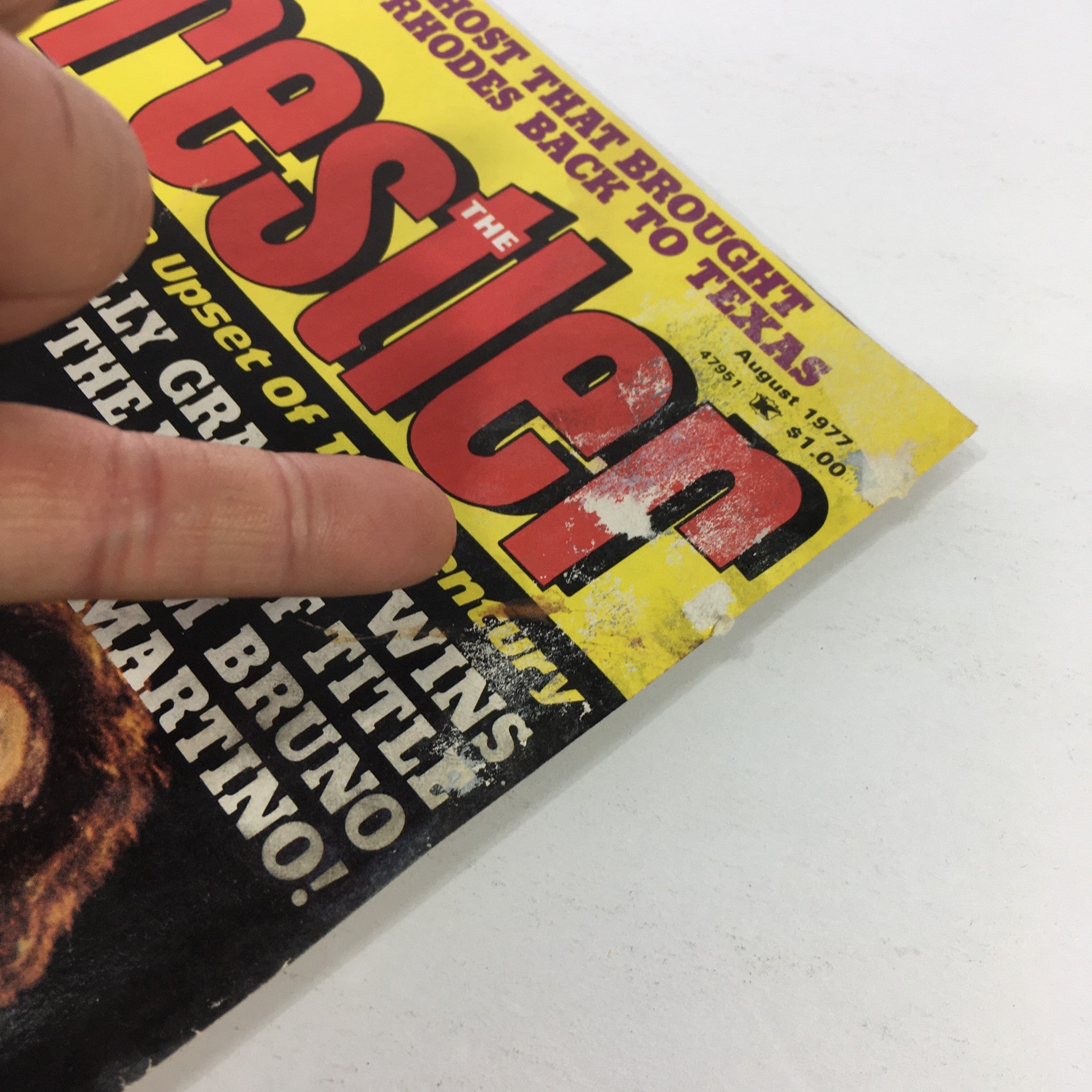 Close-up view of the cover of VTG The Wrestler Magazine August 1977 featuring Billy Graham vs Bruno Sammartino, highlighting wear and tear on the magazine.