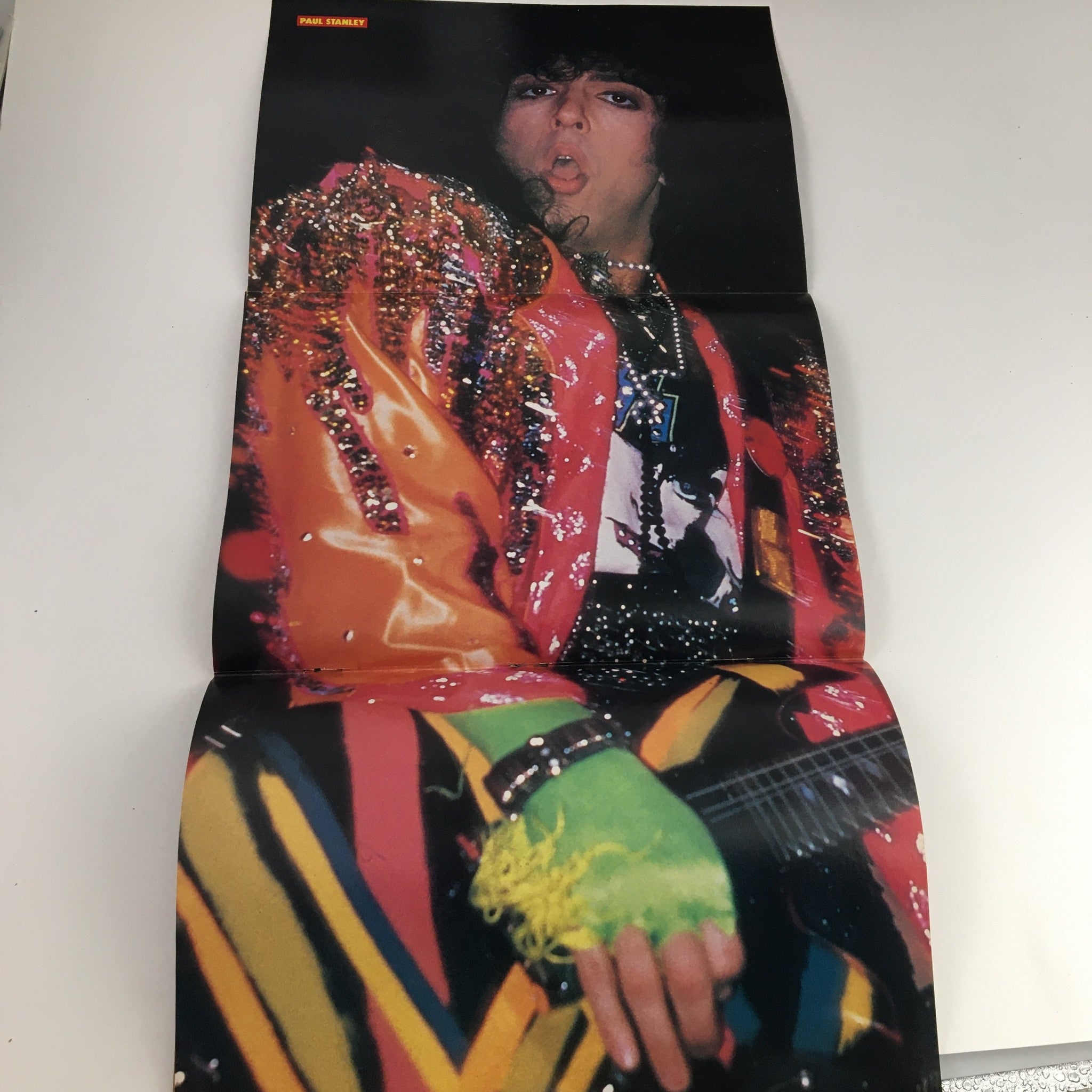Fold-out poster of Paul Stanley from Kiss featured in Rock Scene Metal Mania Magazine July 1986, showcasing his vibrant performance attire.