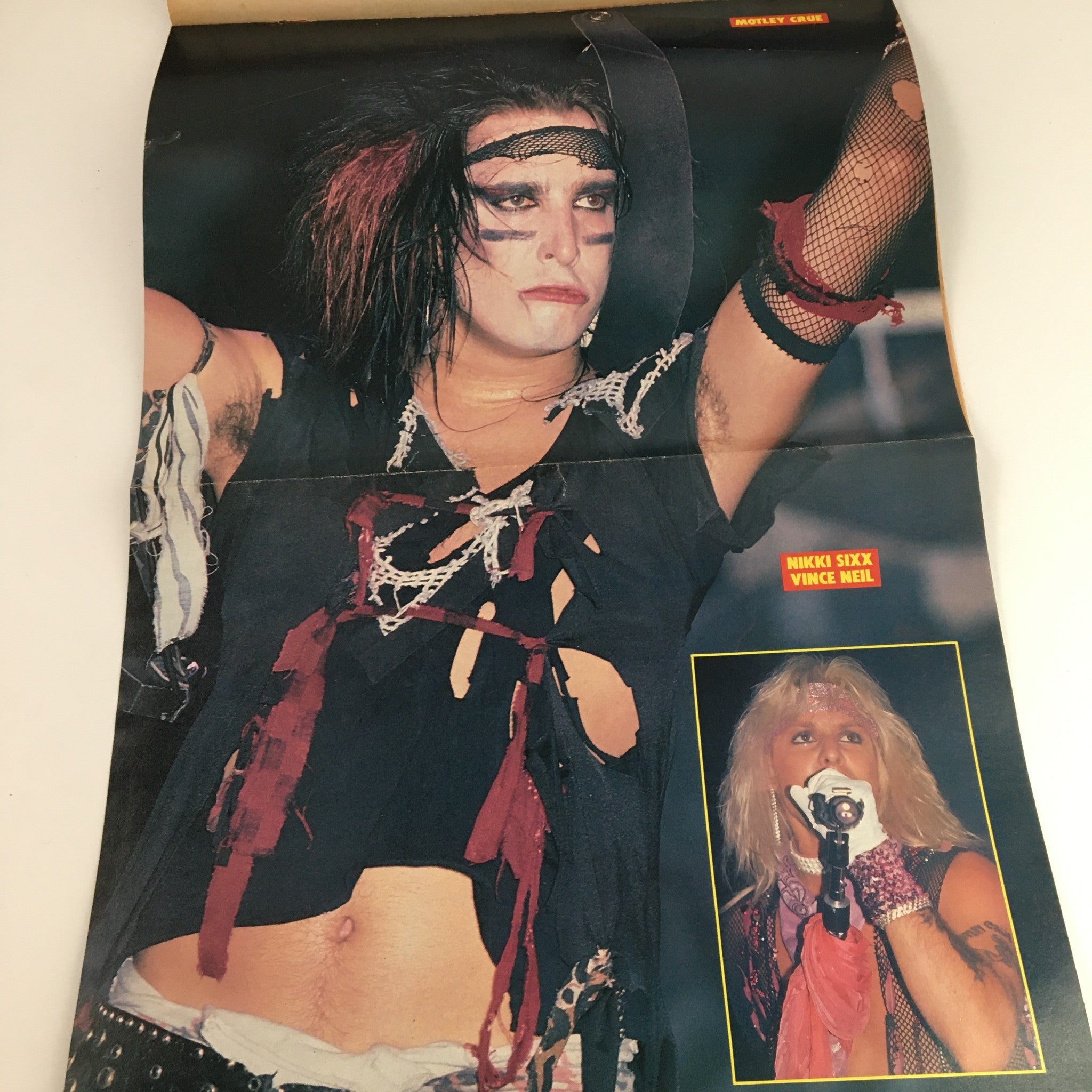 Fold-out poster of Nikki Sixx and Vince Neil from Mötley Crüe in Rock Scene Metal Mania Magazine July 1986, capturing their rock star aesthetic.