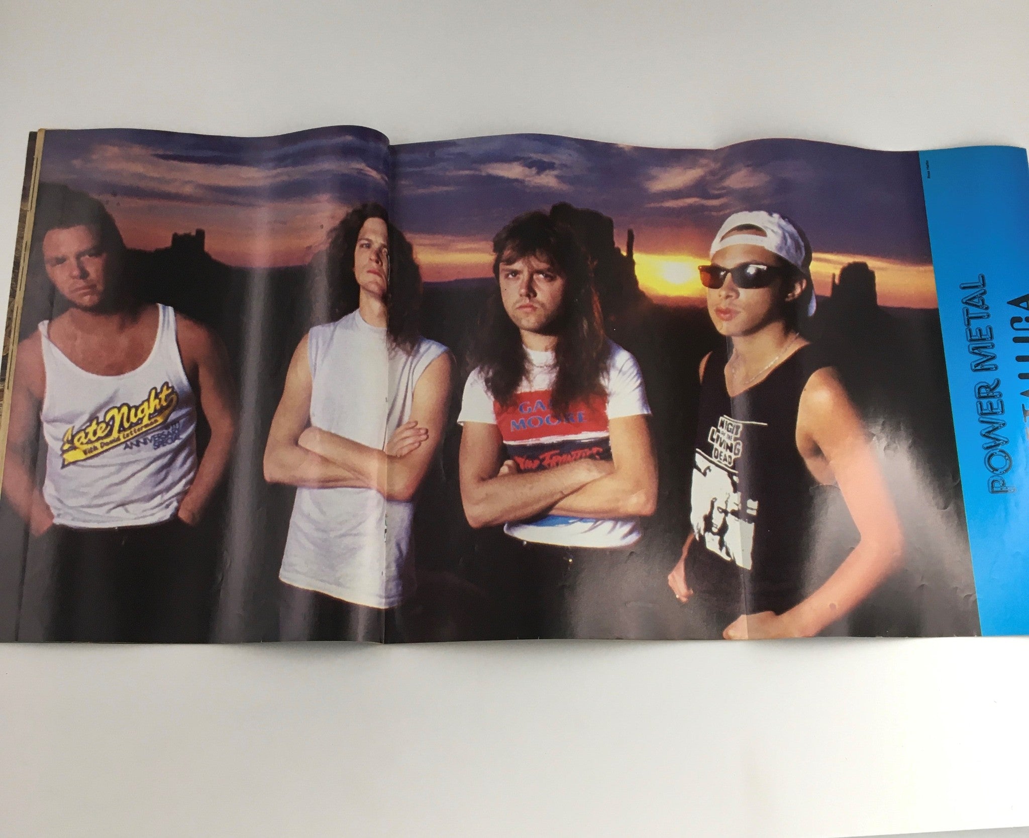 An iconic foldout image from Power Metal Magazine April 1989 featuring a band in a sunset backdrop, showcasing the heavy metal culture.