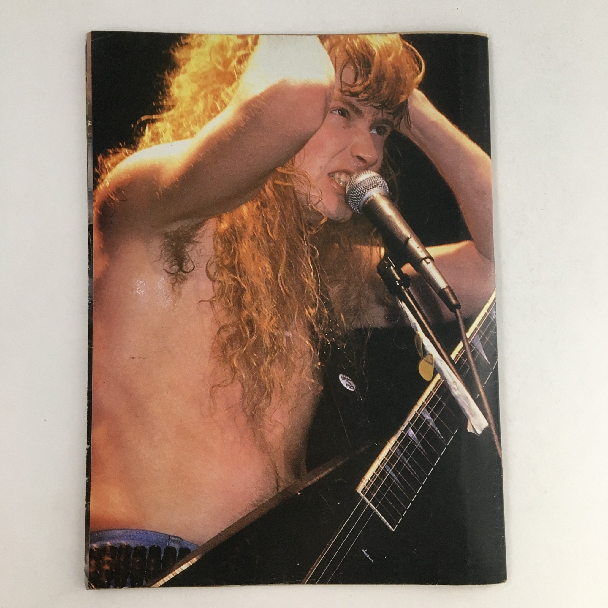 Cover image of Metal Mania Magazine October 1987, featuring a prominent male musician expressing energy and emotion during a live performance.