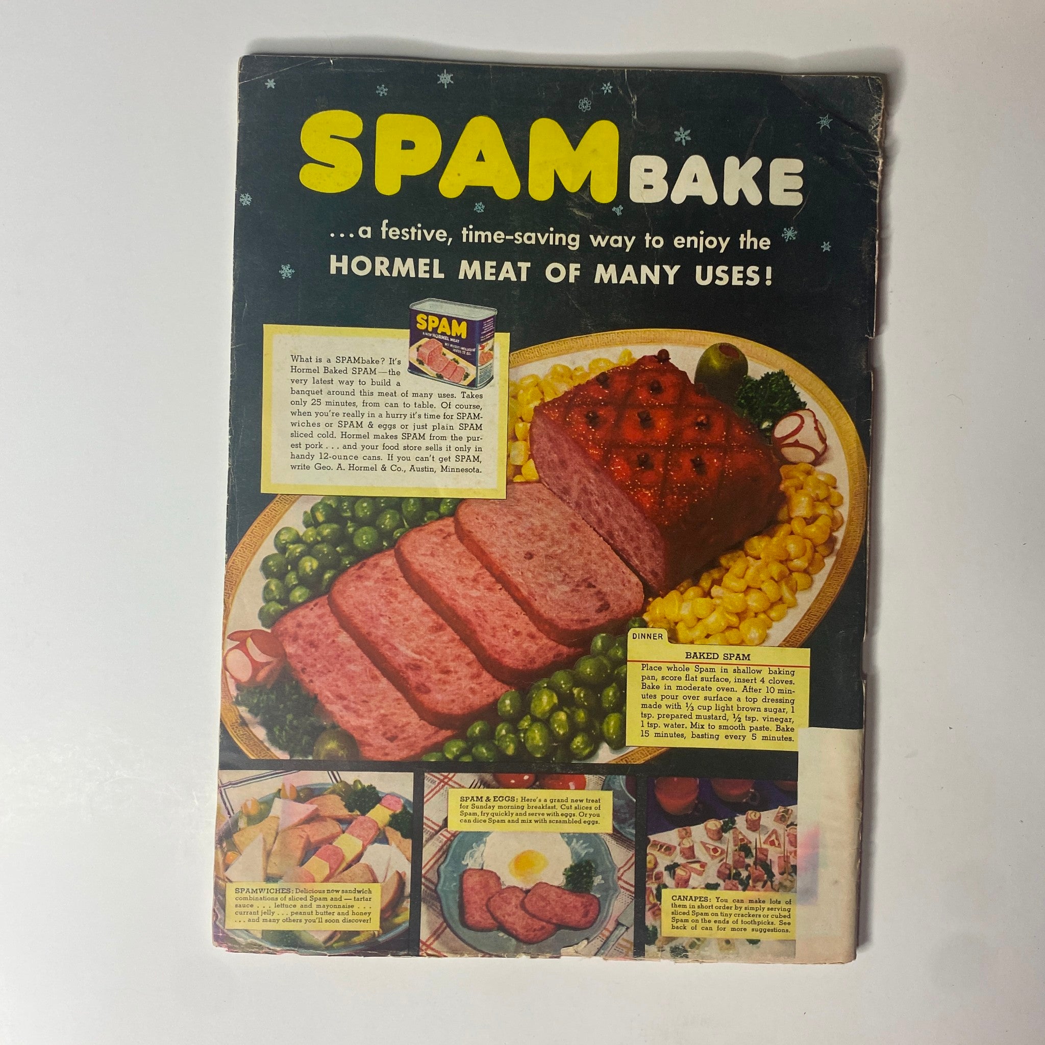 Cover of a vintage advertisement for SPAM Bake, showcasing a festive dish featuring Hormel meat. The ad presents SPAM as a versatile ingredient for various recipes.