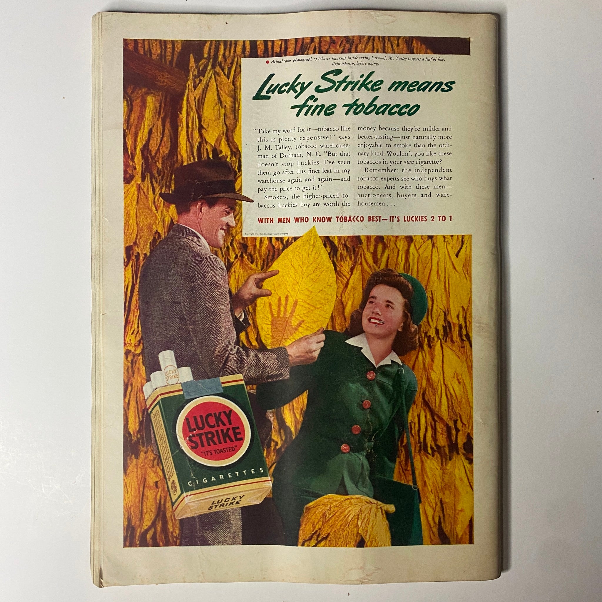 Back cover of Time Magazine October 27, 1941 featuring a vintage advertisement for Lucky Strike cigarettes, showcasing a man and woman in a tobacco warehouse, promoting the quality of Lucky Strike cigarettes.