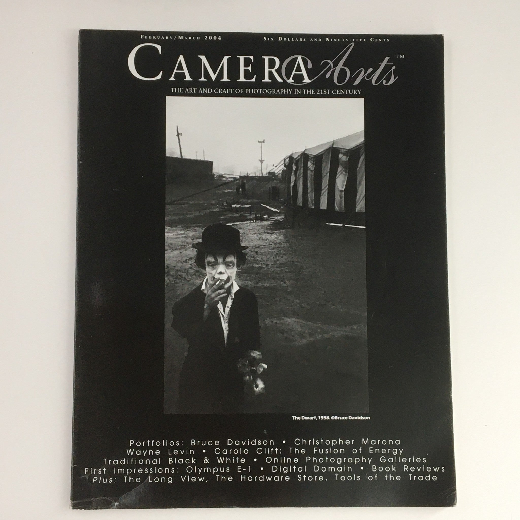 Camera Arts Magazine February 2004 featuring Bruce Davidson's photograph 'The Dwarf 1958' on the cover, showcasing a black and white image of a clown character.
