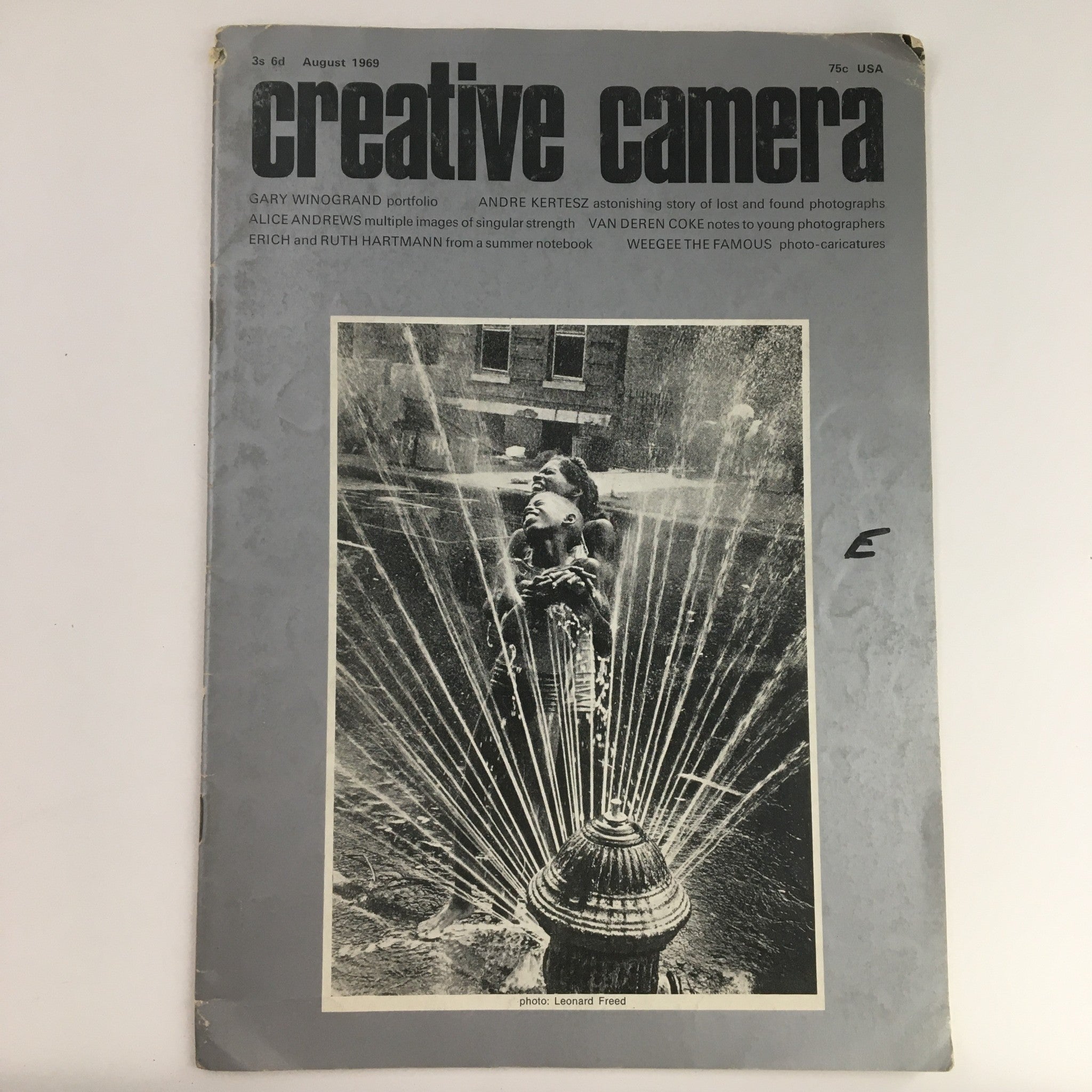 Creative Camera Magazine August 1969 cover featuring a portfolio by Gary Winogrand, showcasing vintage photography with playful imagery of children by a fire hydrant, a representation of urban life in the 1960s.