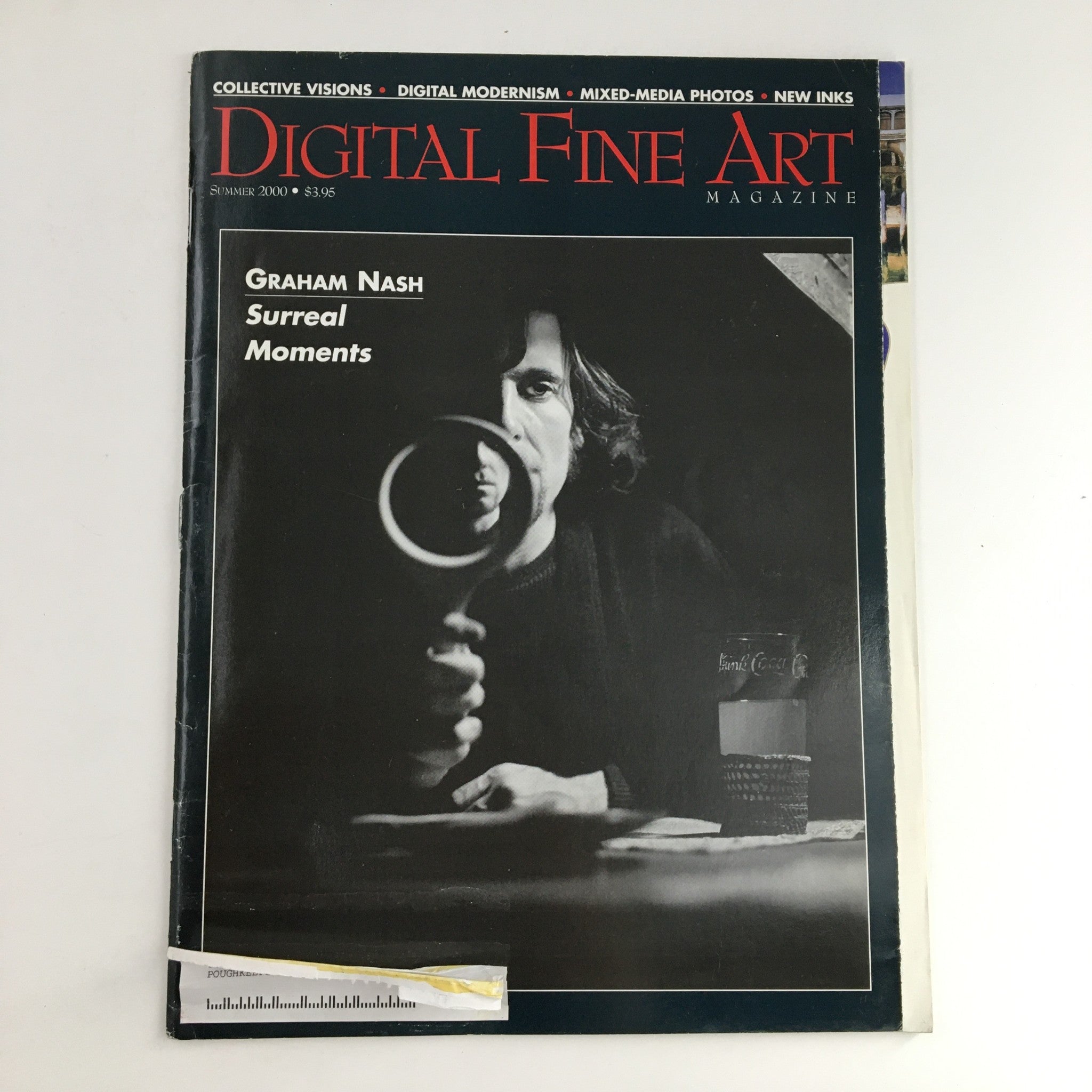 Cover of Digital Fine Art Magazine Summer 2000 featuring Graham Nash and an article on Surreal Moments. The cover showcases striking black and white photography with a man holding a magnifying glass, symbolizing art exploration.