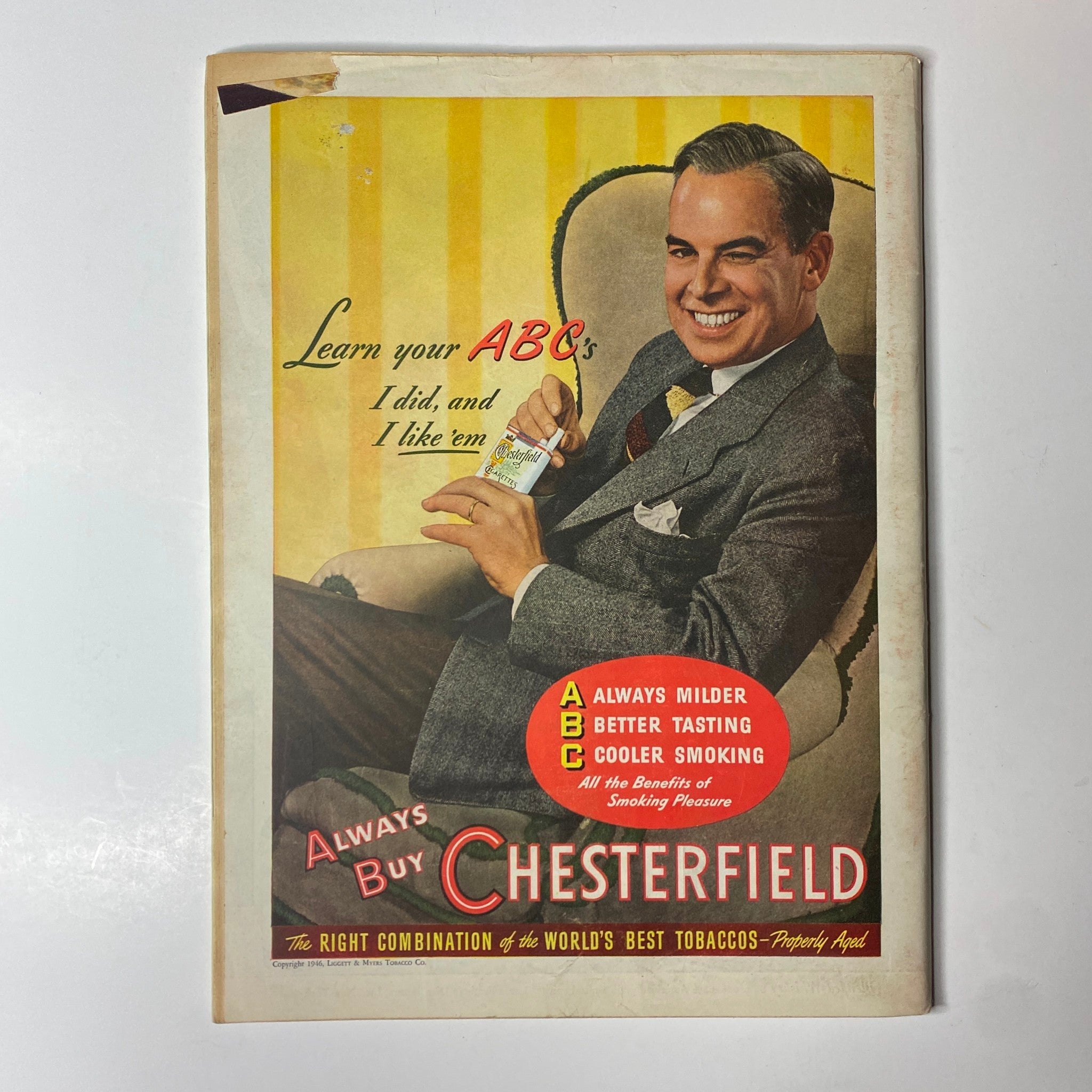Vintage advertisement for Chesterfield cigarettes featuring a smiling man promoting their milder taste.
