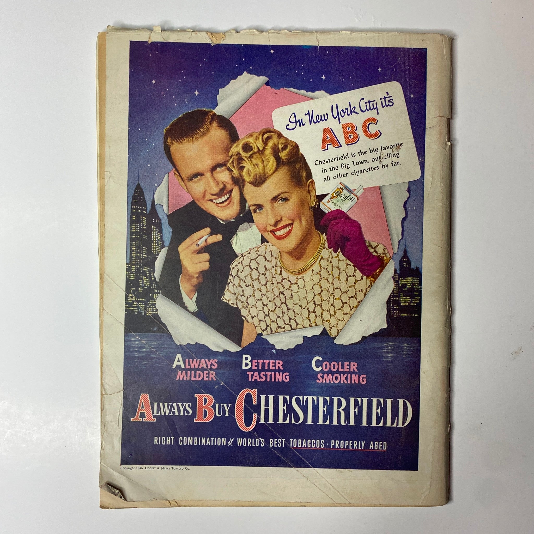 Vintage advertisement for Chesterfield cigarettes in an issue of Time Magazine, showcasing a smiling couple against a city skyline, promoting Chesterfield as the preferred cigarette brand.