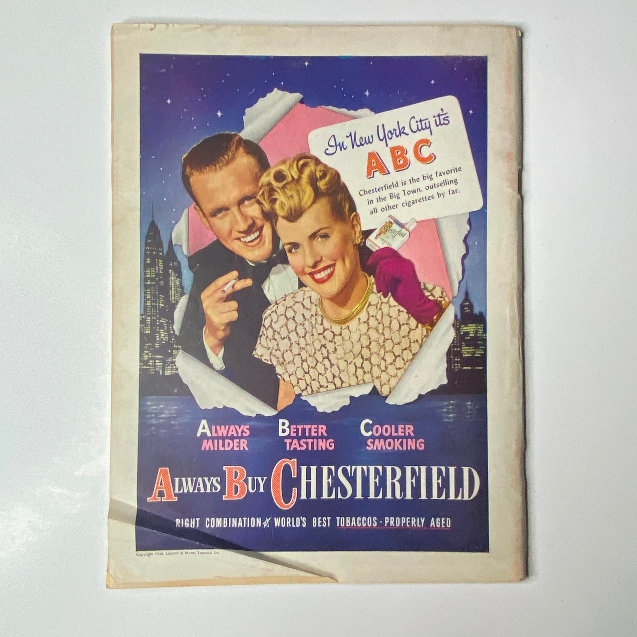 Vintage Chesterfield cigarette advertisement featuring a smiling couple in New York City with the slogan 'Always Buy Chesterfield', promoting the brand's milder and better-tasting tobacco.