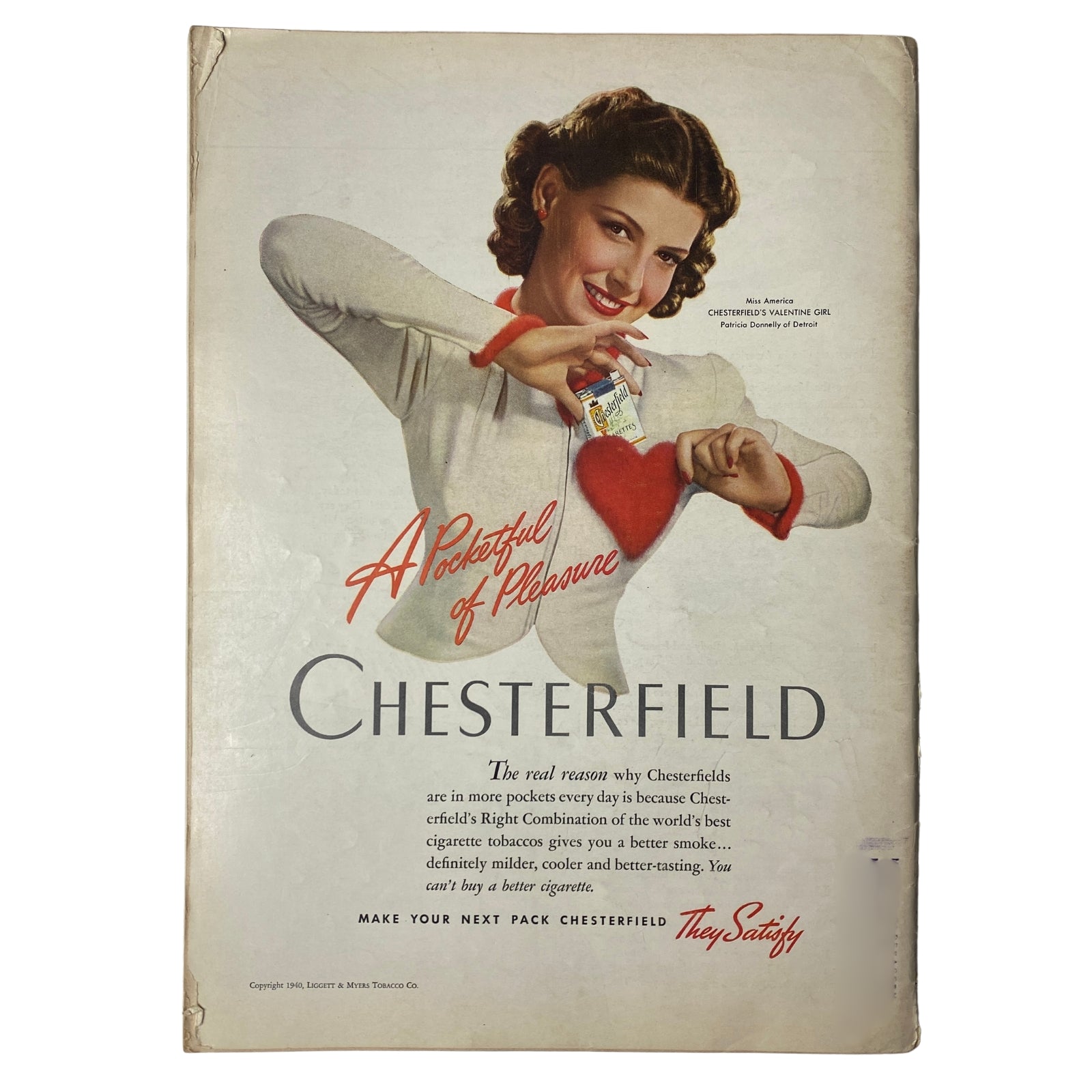 Back cover of a vintage Chesterfield cigarette advertisement showcasing a smiling woman holding a cigarette pack, titled 'A Pocketful of Pleasure'.