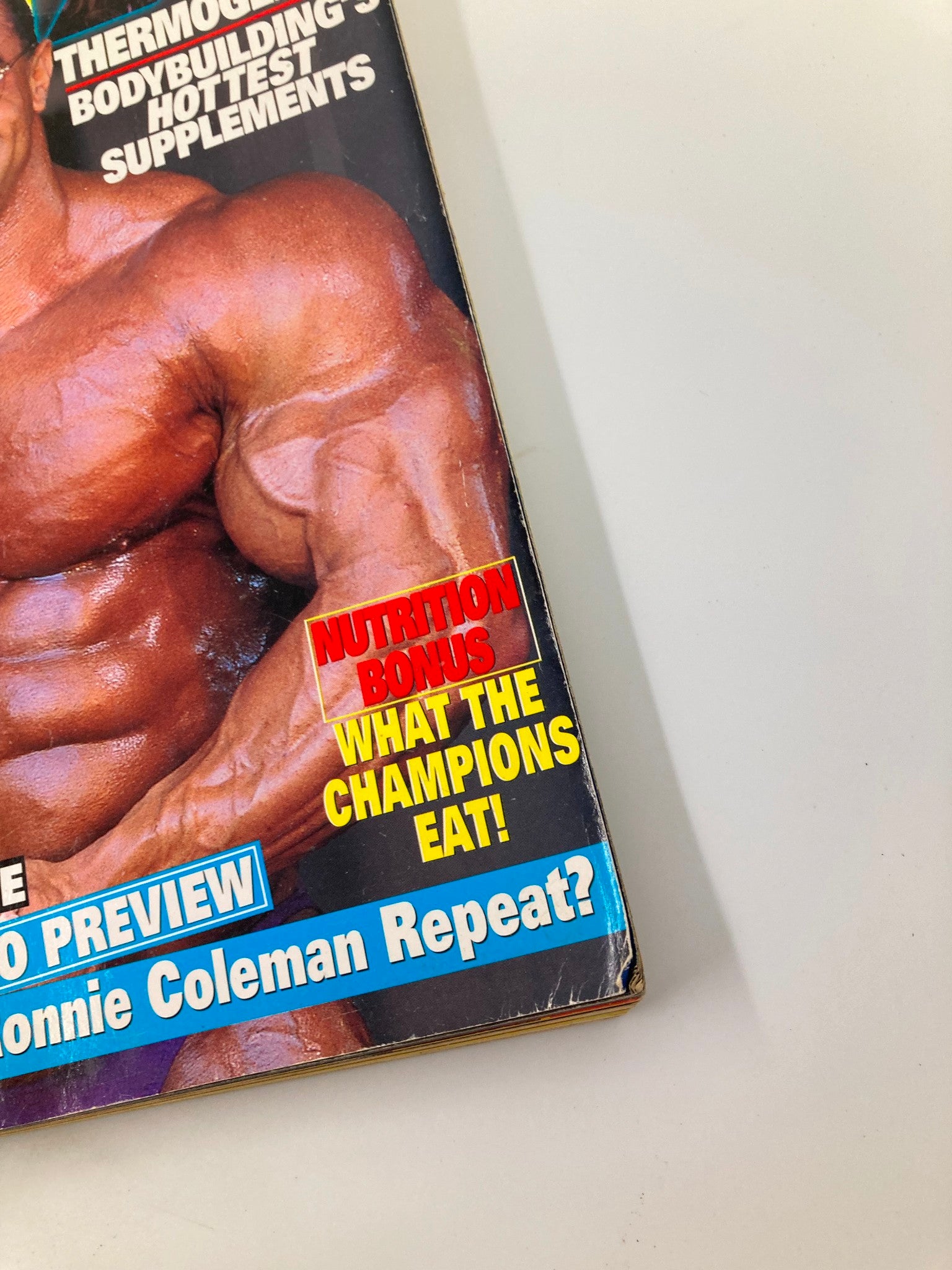 Close-up of the cover details on Joe Weider's Flex Magazine September 1999, showcasing features like nutrition tips, training previews, and the bold question, 'Can Ronnie Coleman Repeat?'