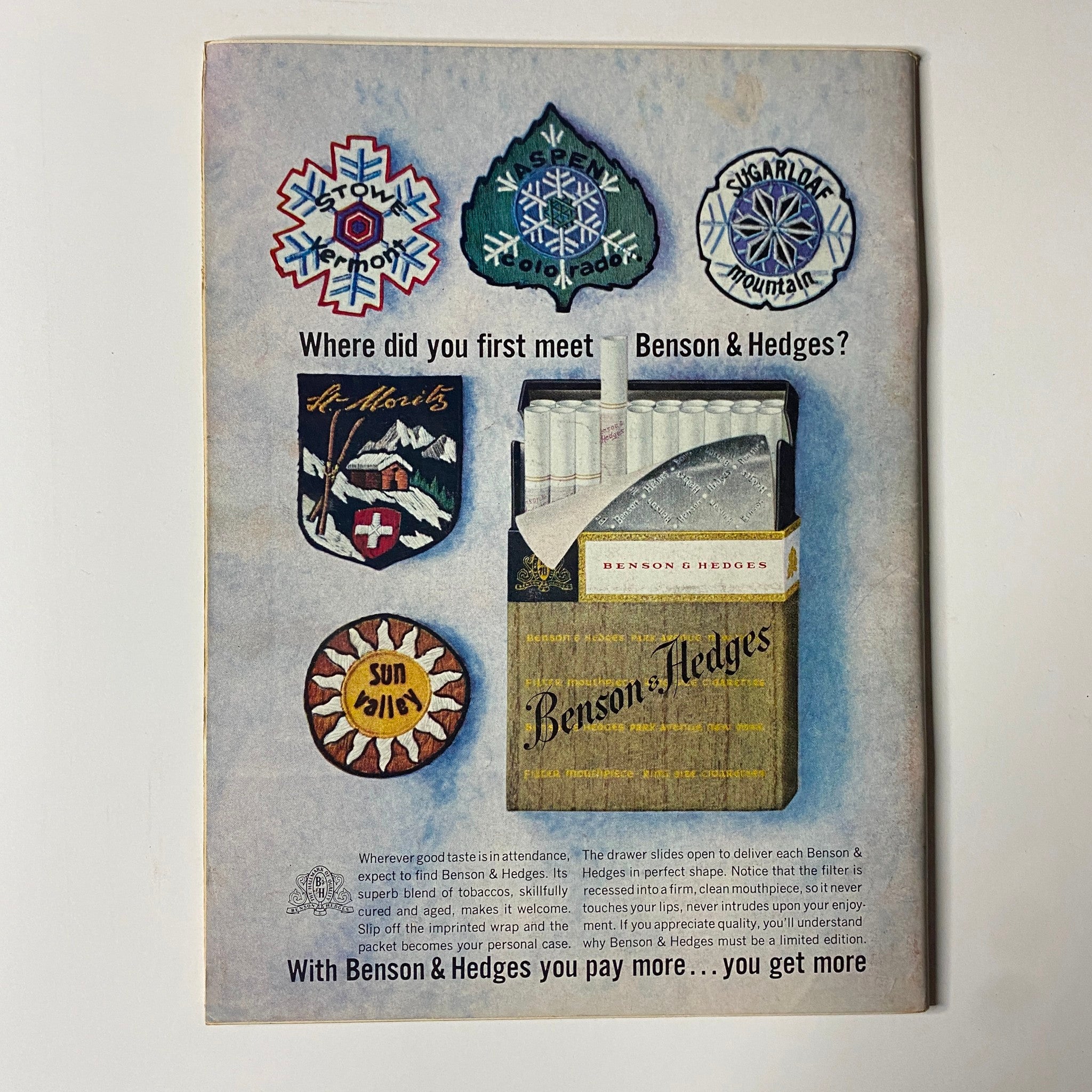 Back cover advertisement for Benson & Hedges cigarettes, showcasing various ski destination patches and emphasizing the premium quality of the product.