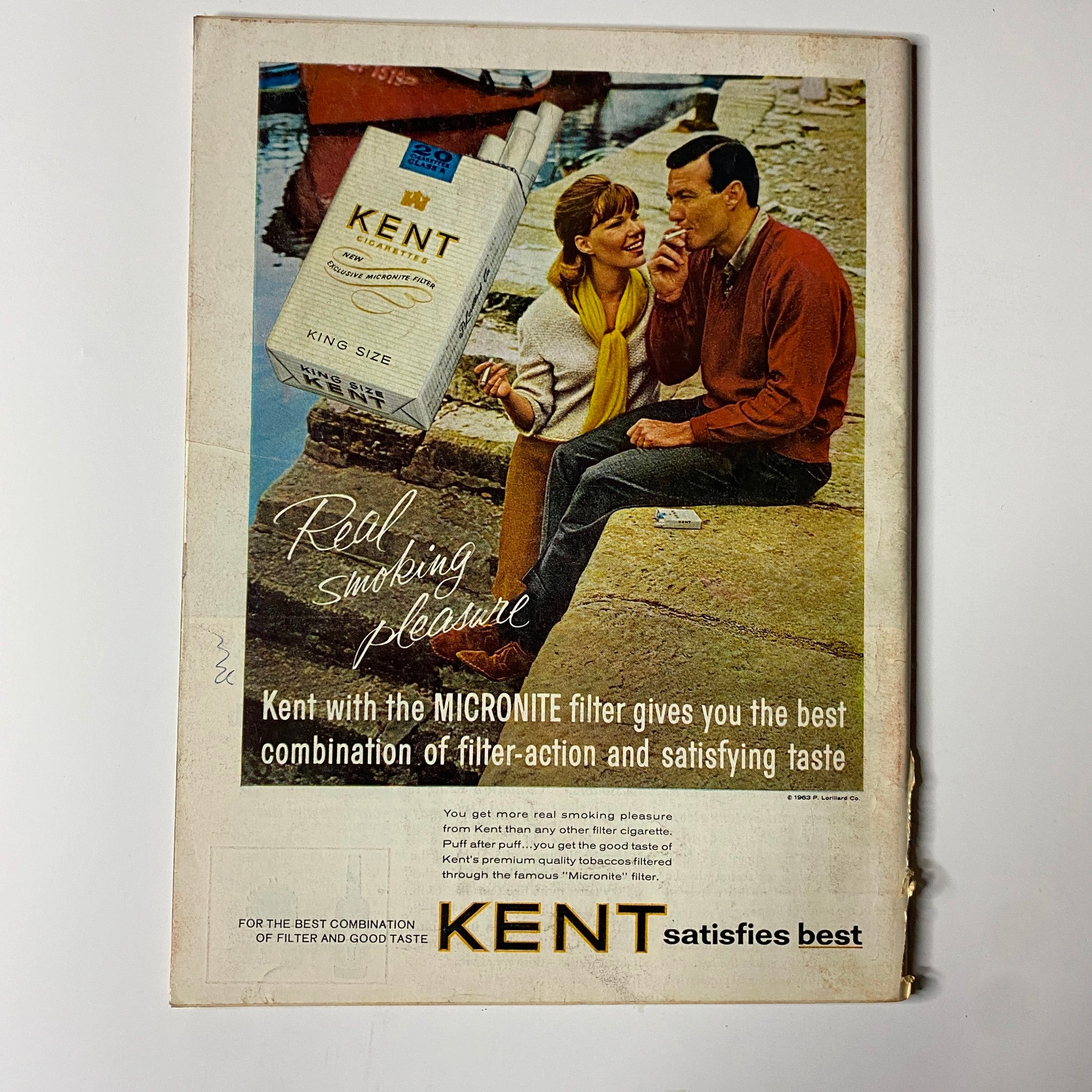 Back cover of Time Magazine October 11, 1963 featuring a vintage advertisement for Kent cigarettes, promoting the Micronite filter with a playful couple in a scenic setting.