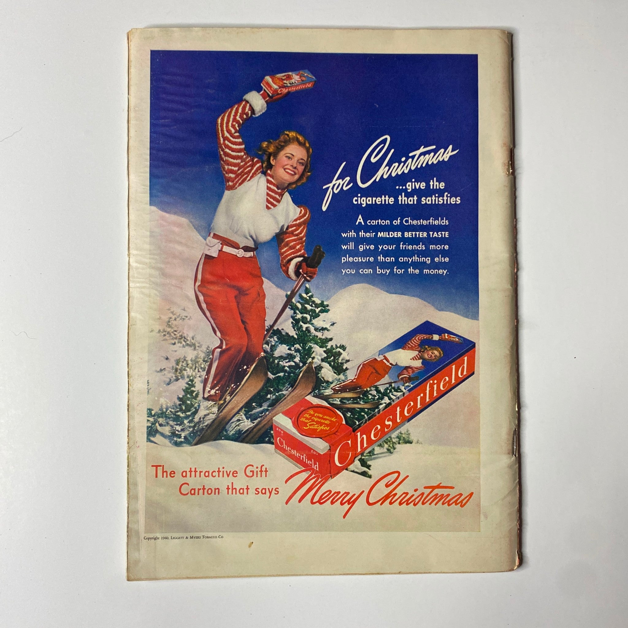 Vintage advertisement for Chesterfield cigarettes from the December 1940 Time Magazine, depicting a skier and holiday greetings, complementing the issue's Christmas theme.